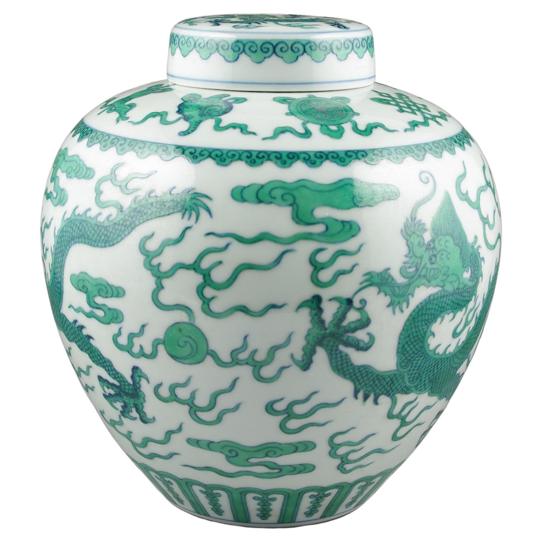 We are delighted to showcase this exquisite Chinese porcelain covered ginger jar, a piece that embodies the pinnacle of craftsmanship and artistic excellence. The jar captivates the beholder with its vibrant depiction of a slithering scaly dragon in