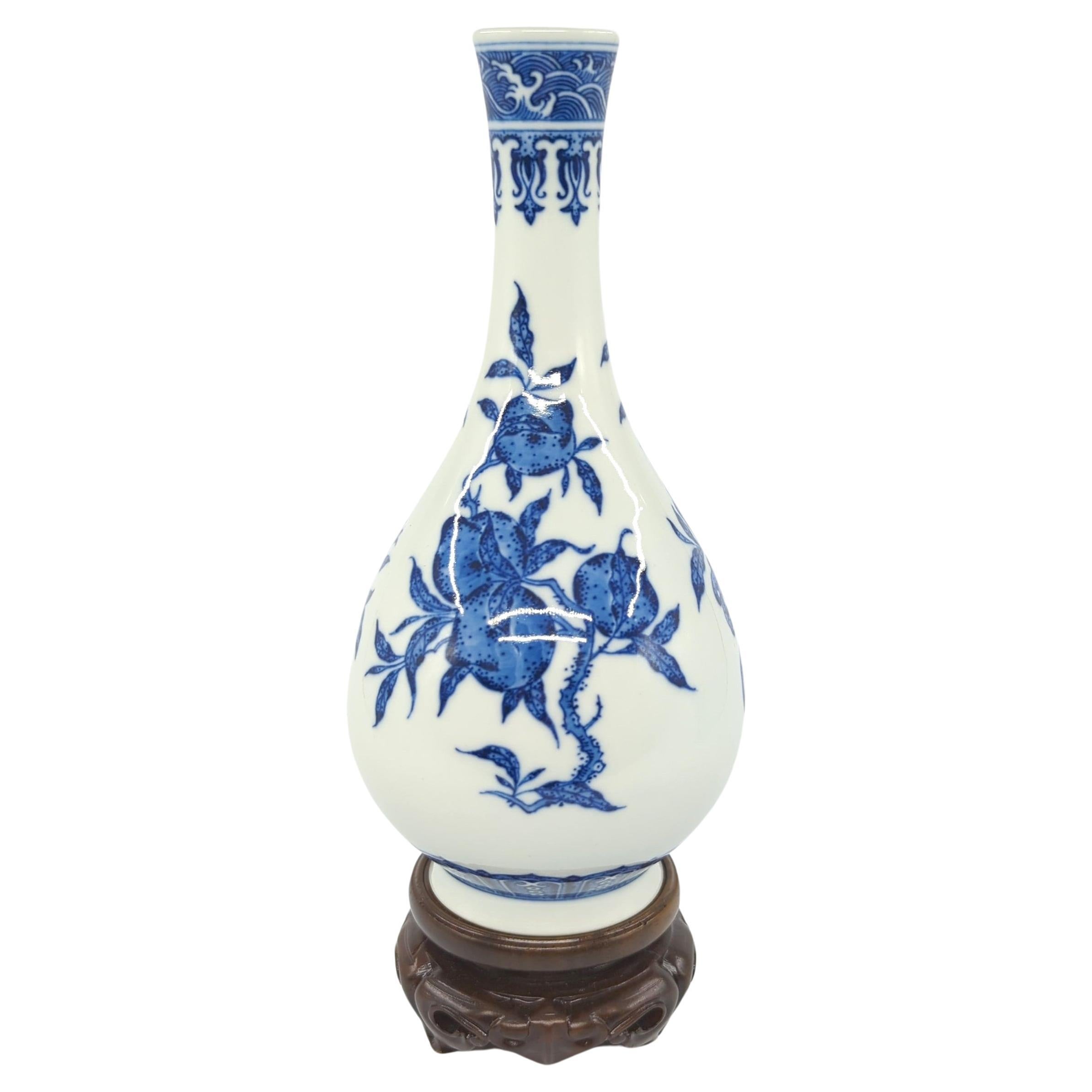 This meticulously crafted Chinese porcelain vase is an exemplary piece of Qing style BW, adorned in underglaze blue and white. The vase assumes a classic bottle form, subtly enhanced by a slightly outward flaring mouth rim.

The central design