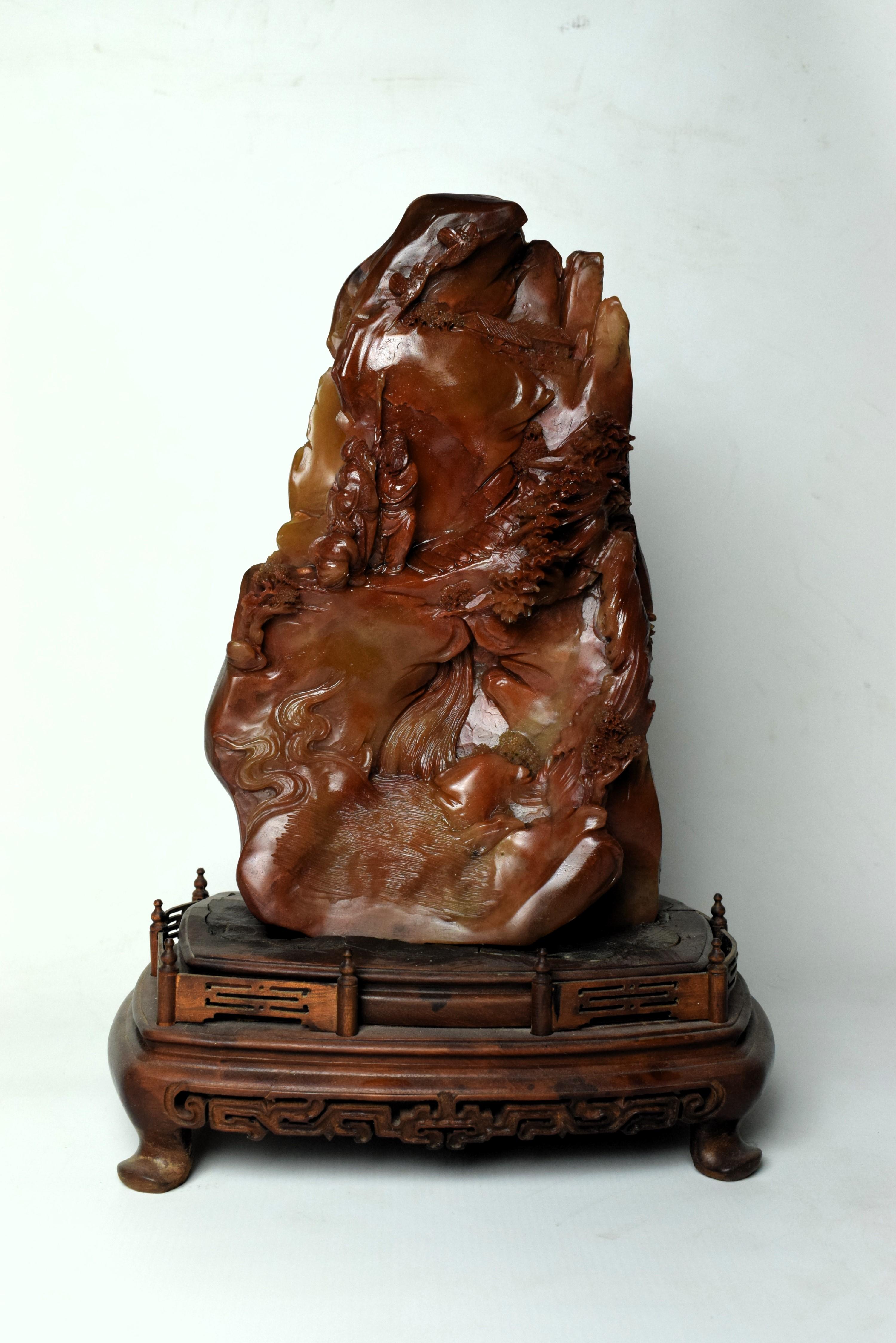 The finely detailed Chinese soapstone carving from the 20th century portrays a picturesque mountain village nestled in a serene landscape. Crafted with exquisite precision, the carving captures the essence of traditional Chinese rural life and the