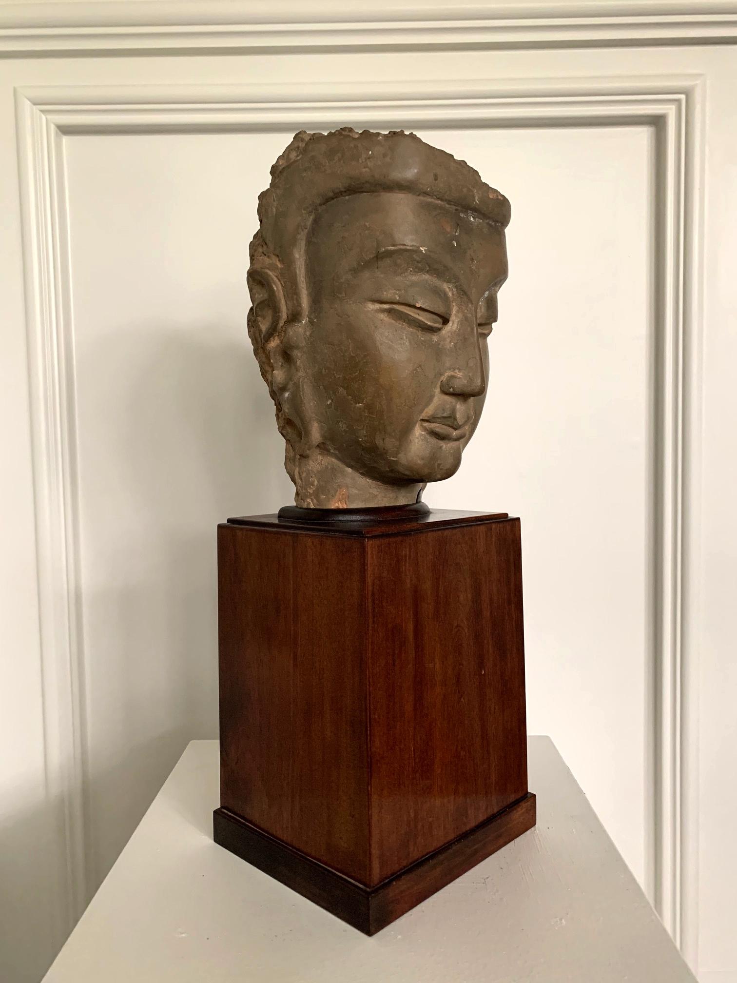 On offer is a fine Bodhisattva head made of stucco around a wood core circa 6th century AD. The fragment was part of high-relief wall sculpture based on its construction. The frontal and the side of the head have been largely preserved in excellent