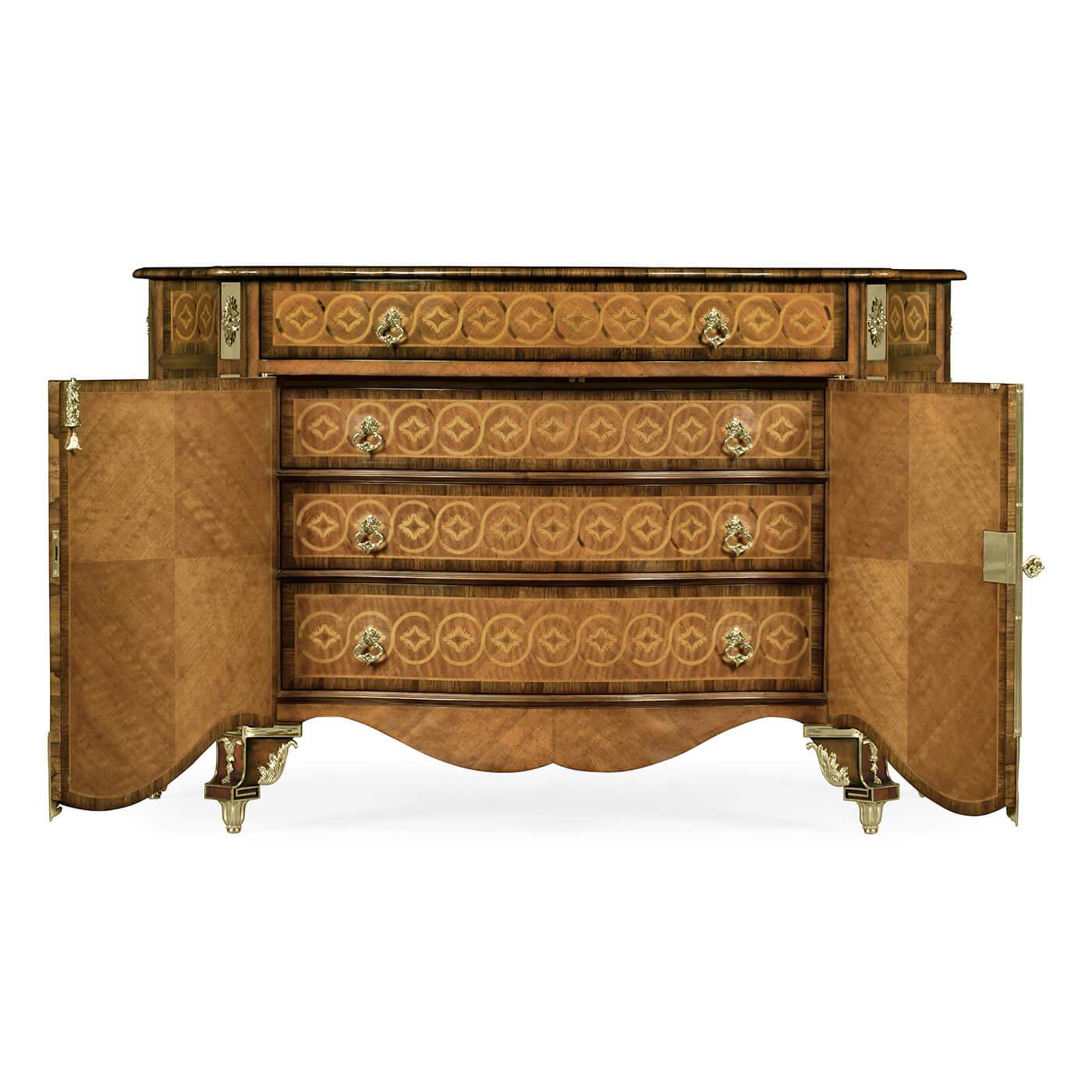 A fine Chippendale style crossbanded and marquetry inlaid chest of drawers with cast brass mounts after a Thomas Chippendale original, the detailed serpentine doors opening to reveal three further graduated drawers within. With elaborate inlays,