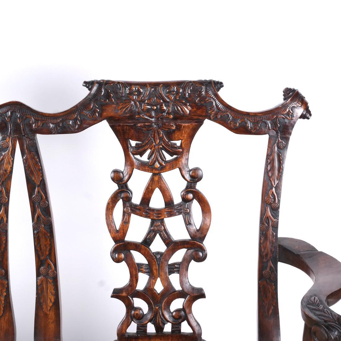A fine quality 19th century carved mahogany triple chair back settee featuring flowers, ribbons, and ball and claw feet, 1880.
