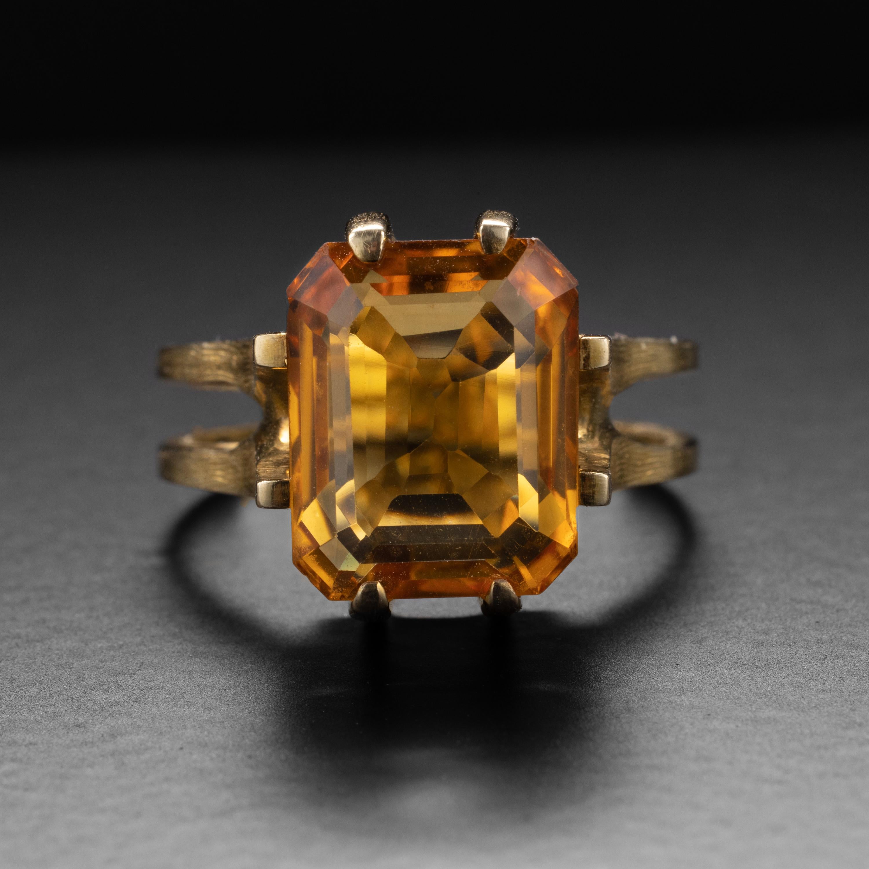 A rich, saturated natural citrine measuring approximately 12.27mm x 9.95 and weighing approximately 5 ¼ carats is the focal point of this truly unique, architectural ring from the Midcentury. 

While there is no maker's mark, the ring is stamped