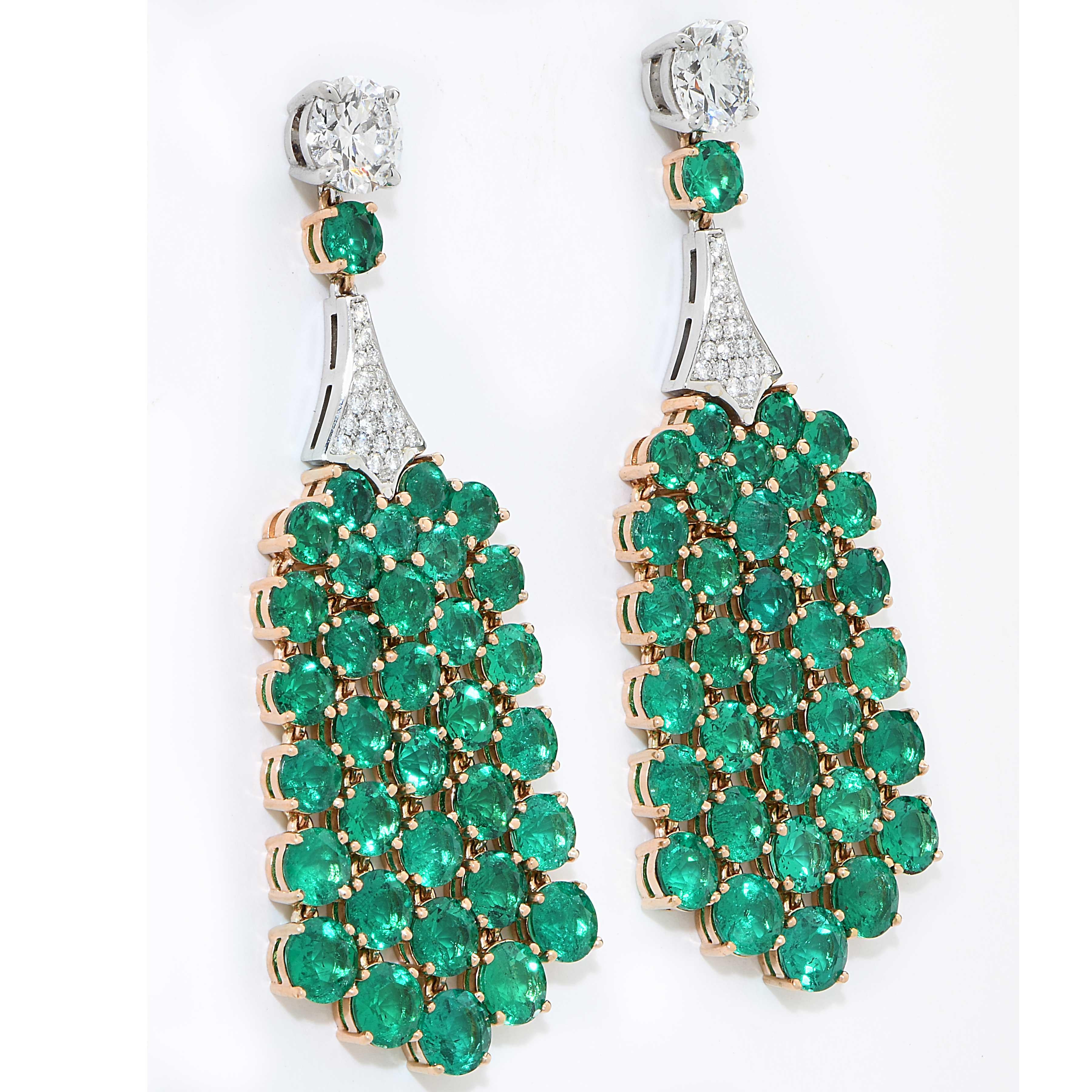 Fine Colombian Emerald and Diamond Earrings featuring 68 round brilliant cut fine Colombian emeralds with a total weight of 15.5 Carats and 40 round brilliant cut diamonds with an estimated total weight of .30 Carats and 2 GIA graded diamonds, 1.02