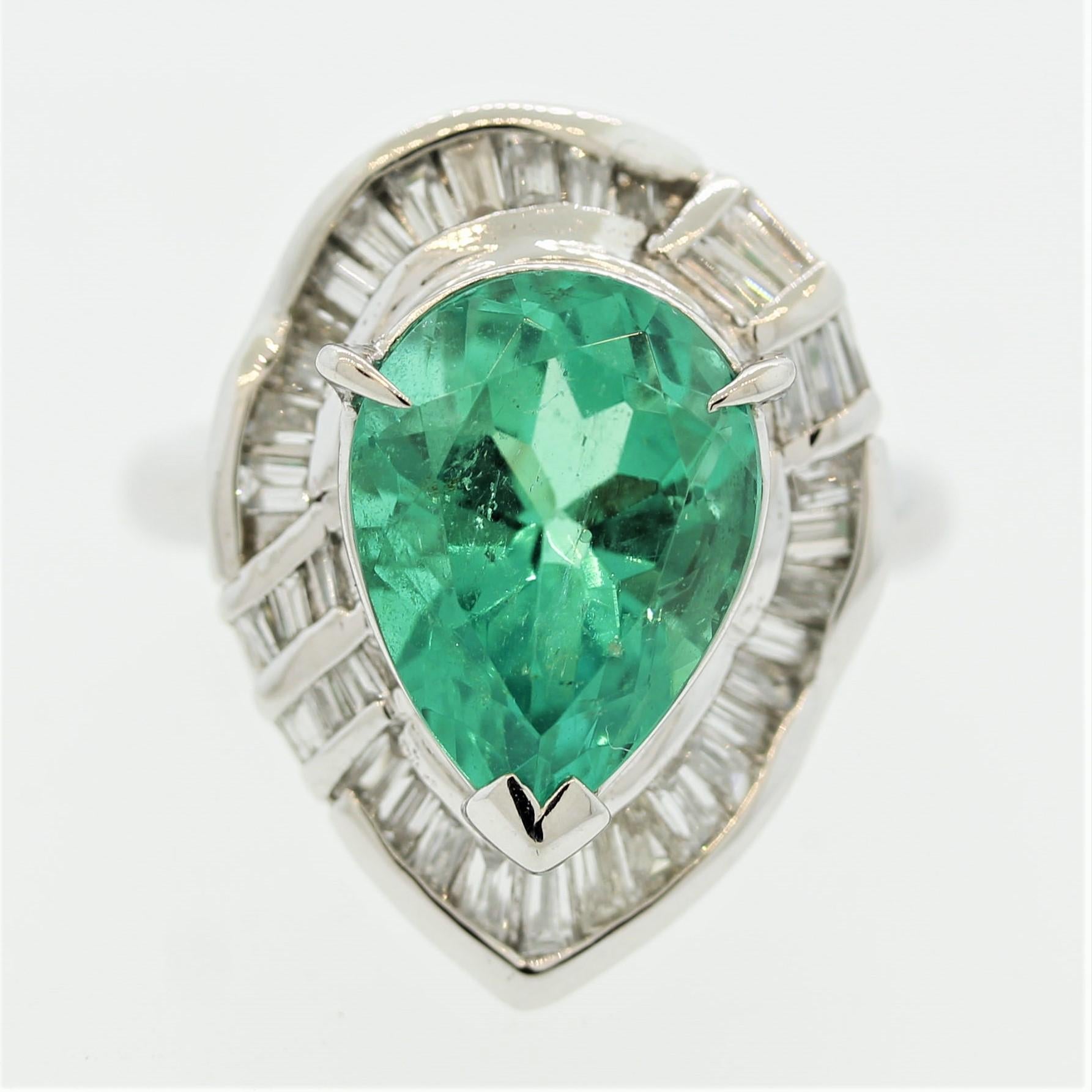 A lovely platinum made ring featuring a 4.38 carat pear-shape Colombian emerald. It has a bright gem green color with excellent brilliance and life. It is also very clean compared to most other emeralds allowing the stones natural brightness to