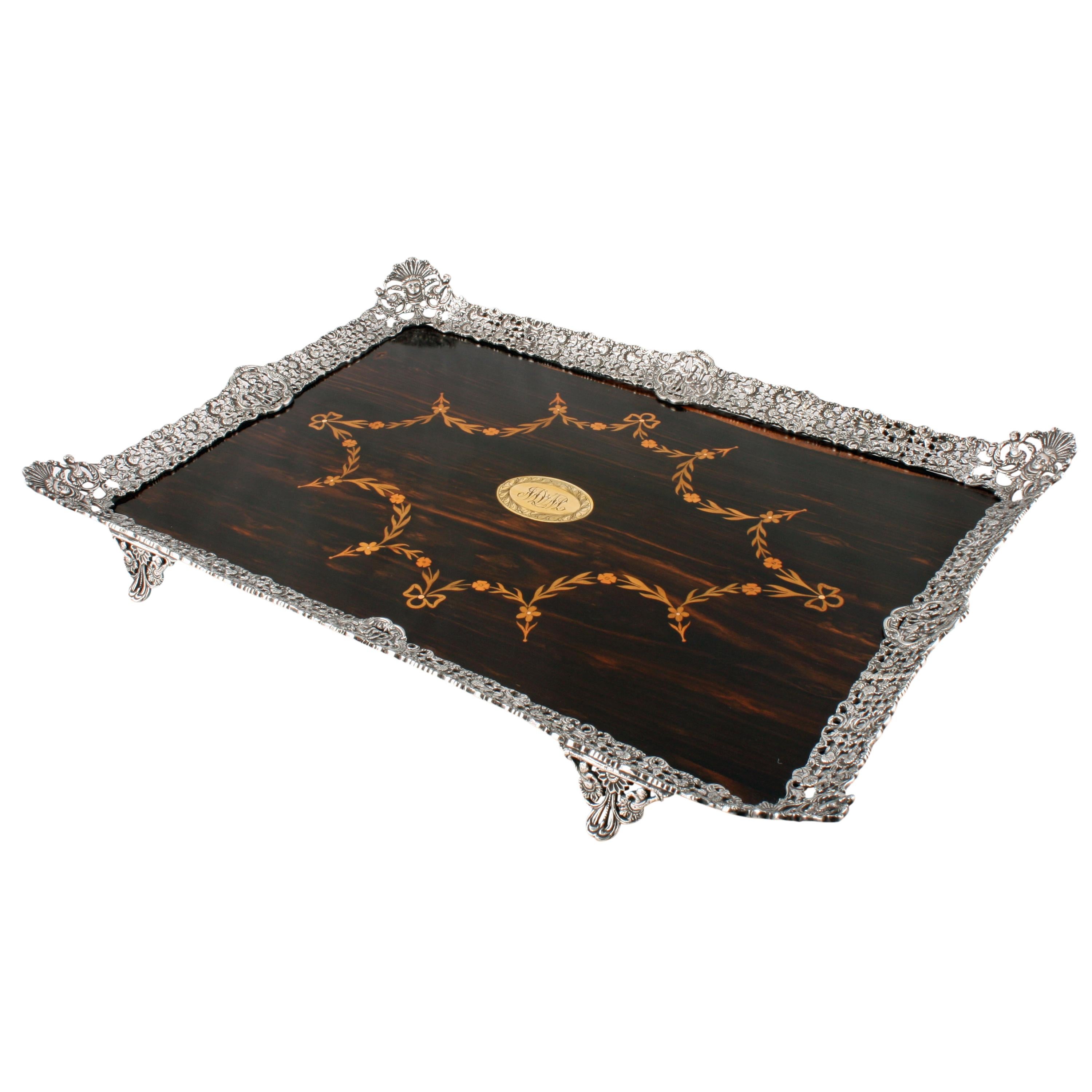 A very unusual fine Victorian coromandel and silver plate tray.

The tray has a coromandel wood center with a silver plated pierced gallery edge and feet.

The center panel is mahogany with coromandel wood veneer and is marquetry inlaid with