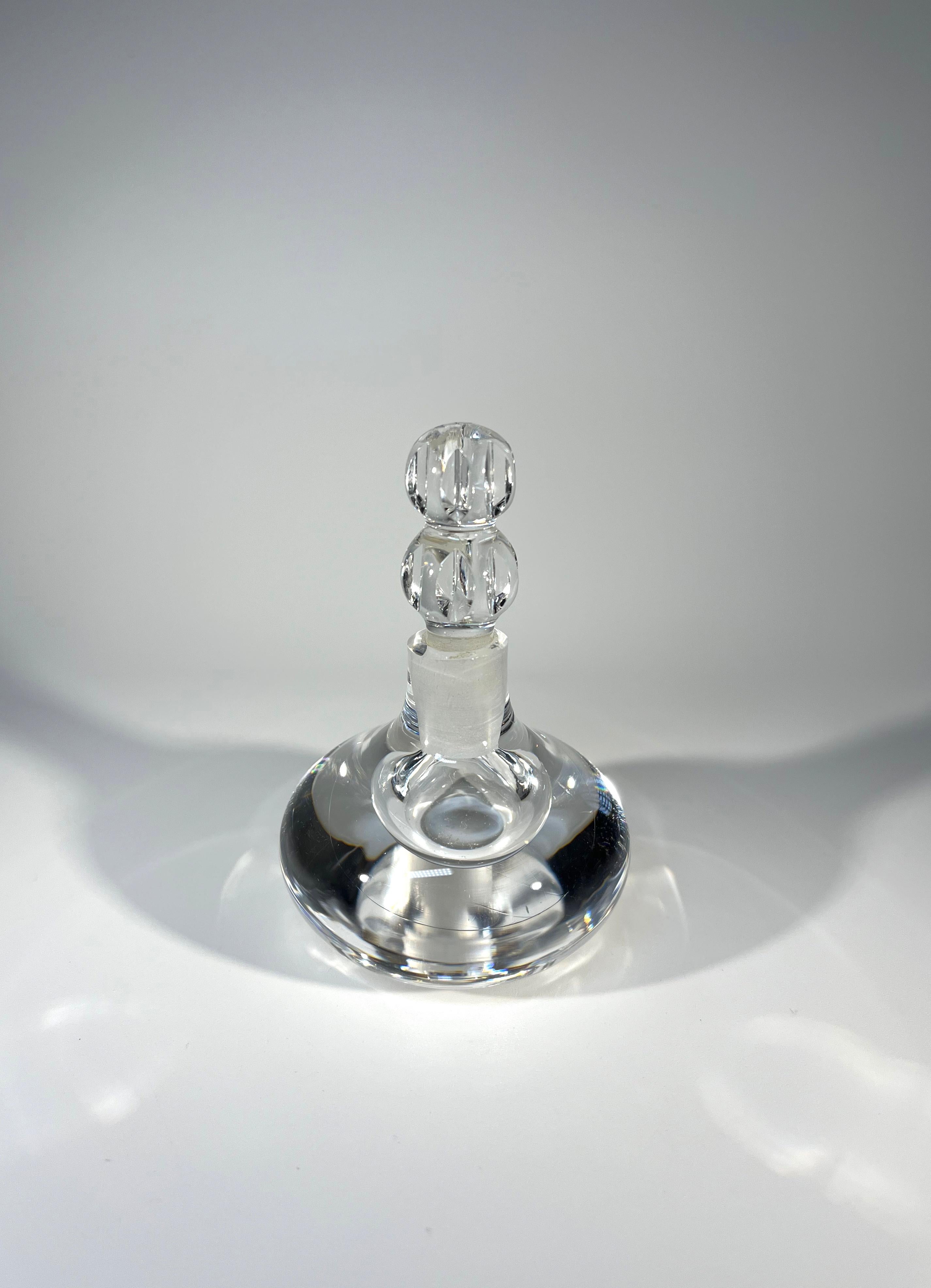 Beautiful and pure, crystal clear perfume bottle by Orrefors, Sweden
Unusually faceted, cut crystal stopper completes this most appealing piece
Circa 1980's 
Height with stopper 3.5 inch, Diameter 2.25 inch
In very good condition
Wear consistent