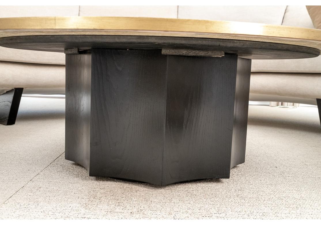 A beautifully crafted Cocktail Table with a Scalloped wood base having black paint decoration surmounted by a particularly attractive Brass Banded Stone top.  The top with captivating Desert colors of Tans, Creams, Pinks and Browns and reminiscent
