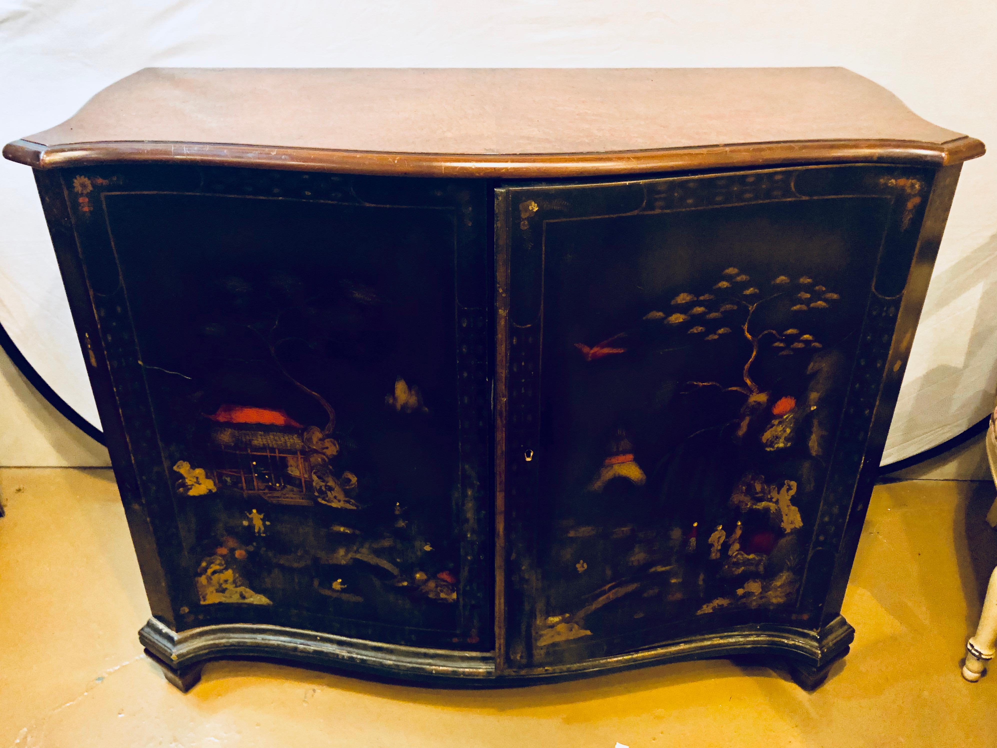 A fine custom quality Chinoiserie commode or cabinet server. The ebonized cabinet having two doors depicting a raised figural scene leading to a shelved interior and supporting a nice burled wood tabletop. The interior having been hand custom