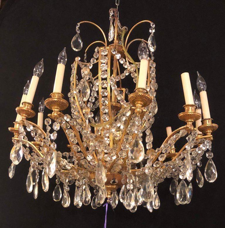 Fine Jansen style cut crystal and gilt bronze neoclassical eighteen light chandelier . This finely cast chandelier was six interior lights and twelve lighted outer candelabra lights. Certain to light up the largest of spaces this neoclassical
