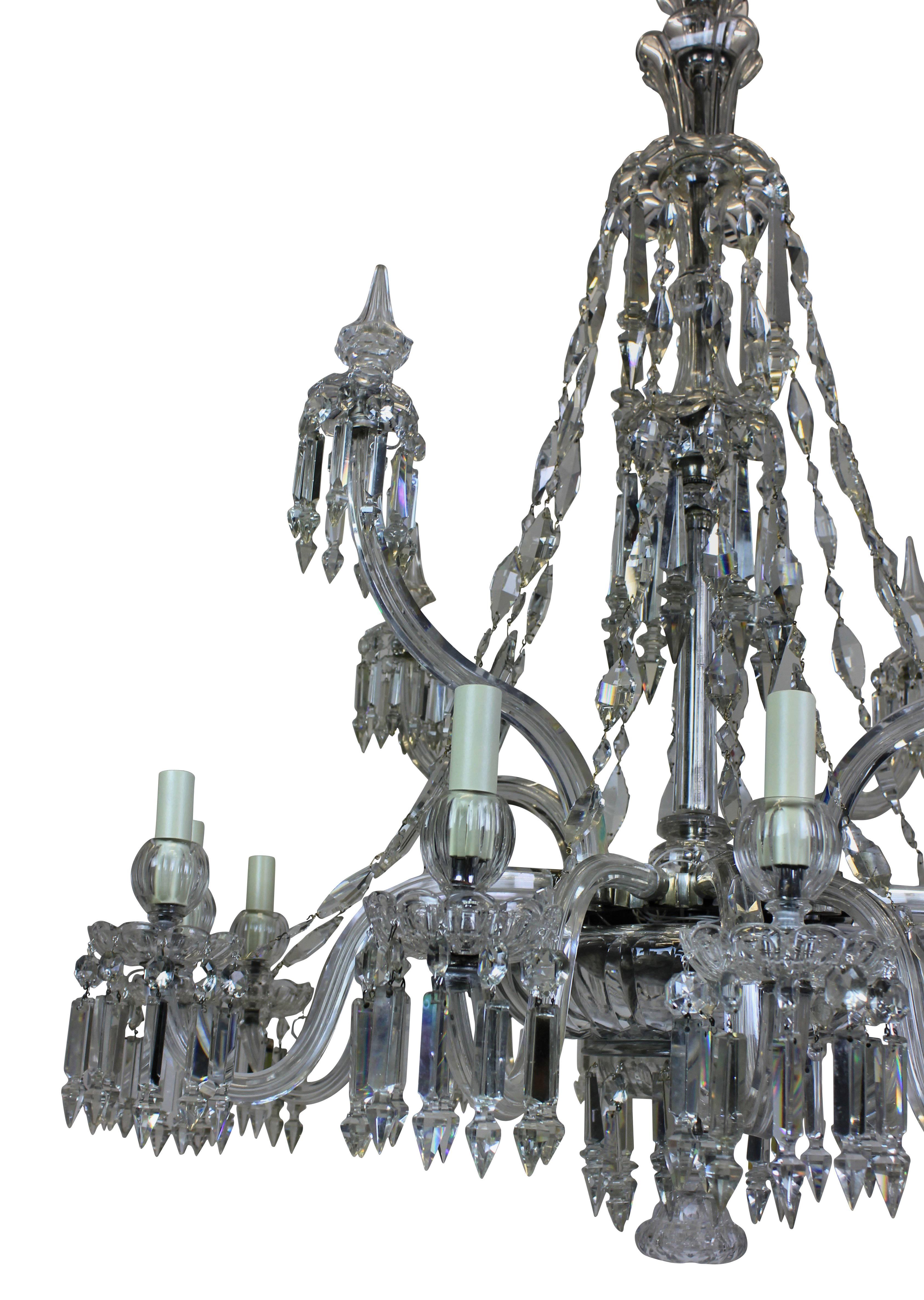 A fine English cut-glass chandelier by F & C Osler. Formerly a gasolier. With twelve arms hung throughout and four large up-swept arms with spikes. The chains of diamond shape are a unique Osler pattern.
 