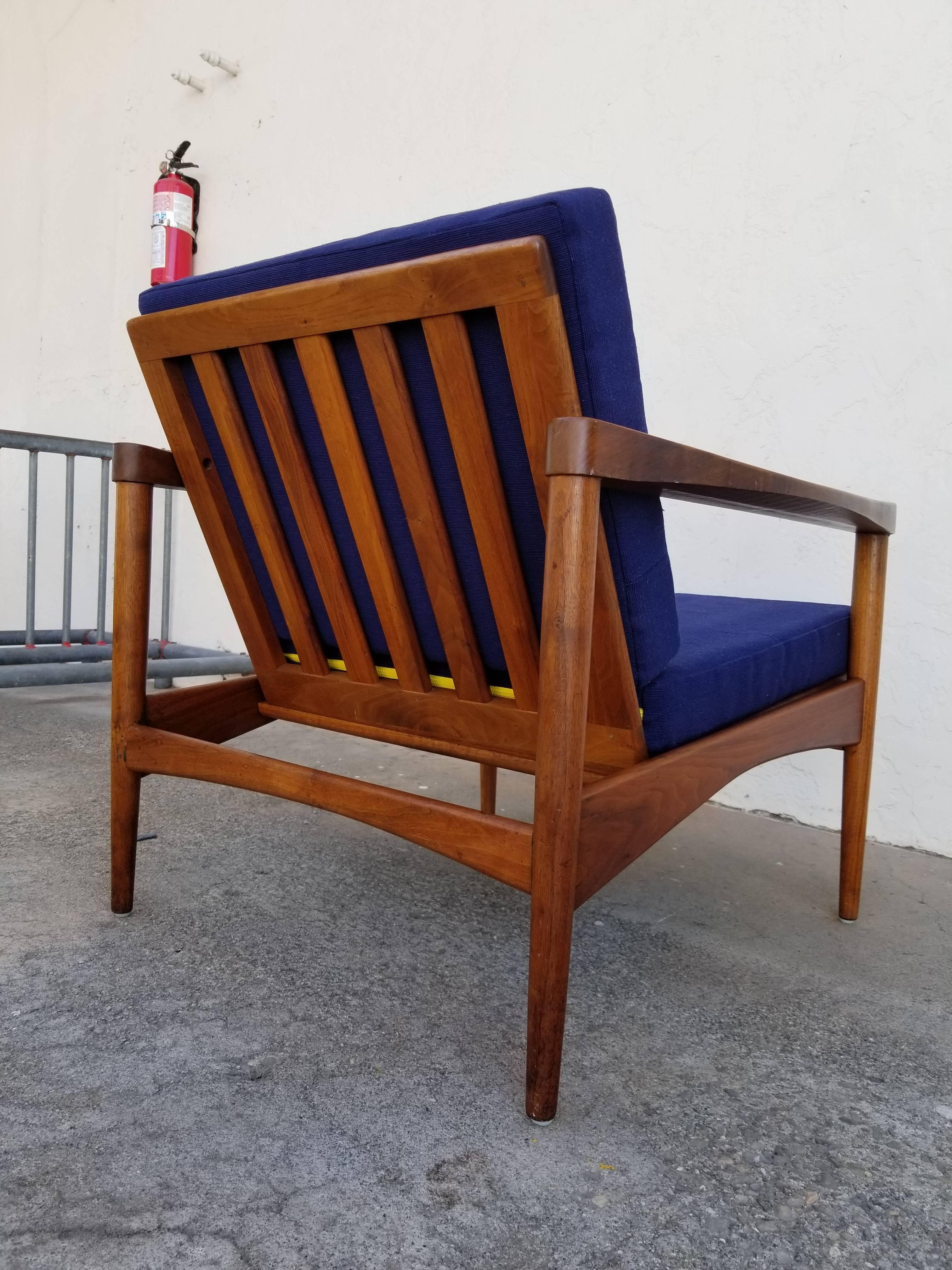 A 1960s Danish modern lounge chair with unique spline detail and beautiful, sculptural design. Crafted in solid walnut.