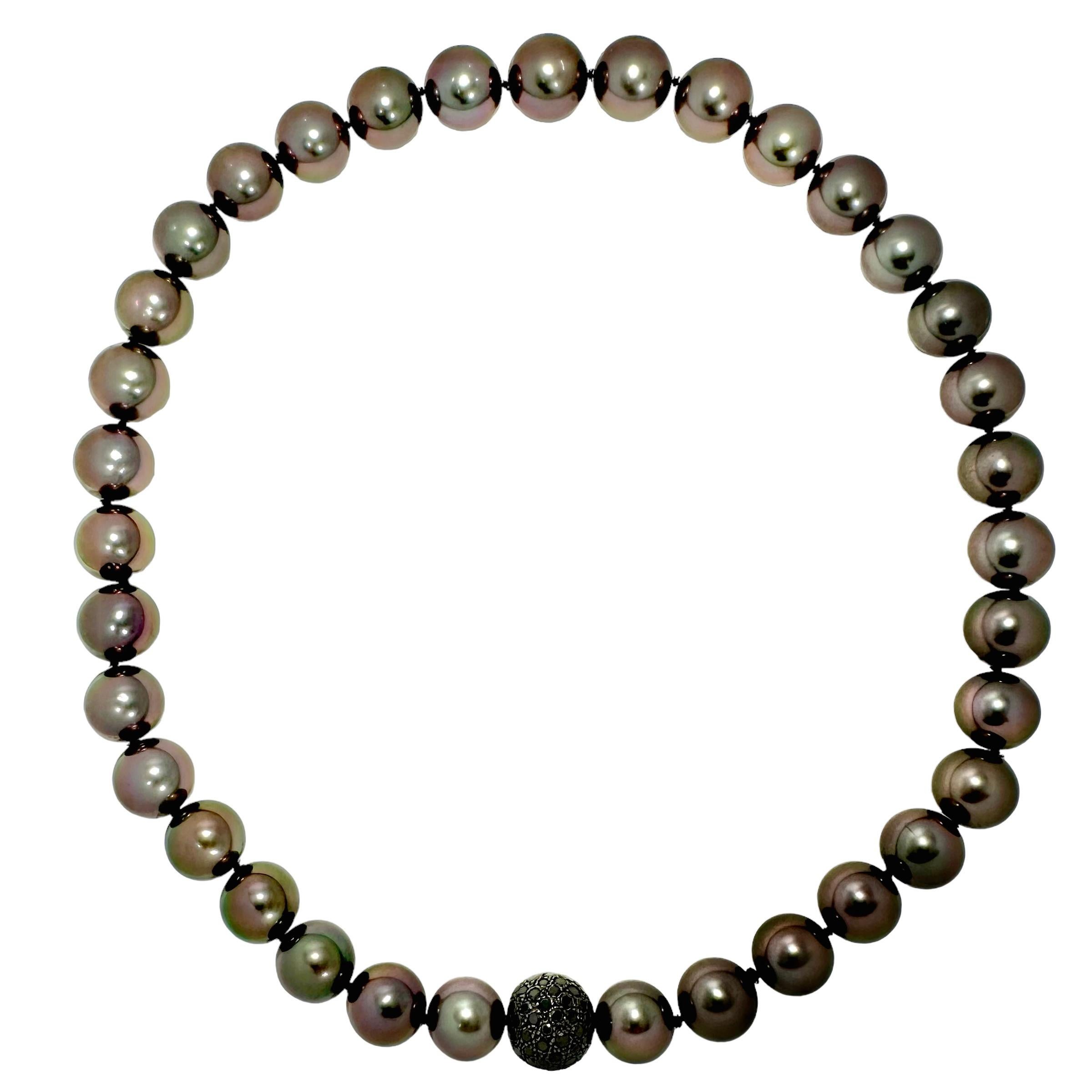This elegant 19 1/2 inch long necklace comprised of thirty five Dark Grey Tahitian cultured pearls terminates in a 14mm black oxidized 14K gold inline ball clasp, heavily set with black diamonds. Pearls range in size from 12.06mm to 14.17mm