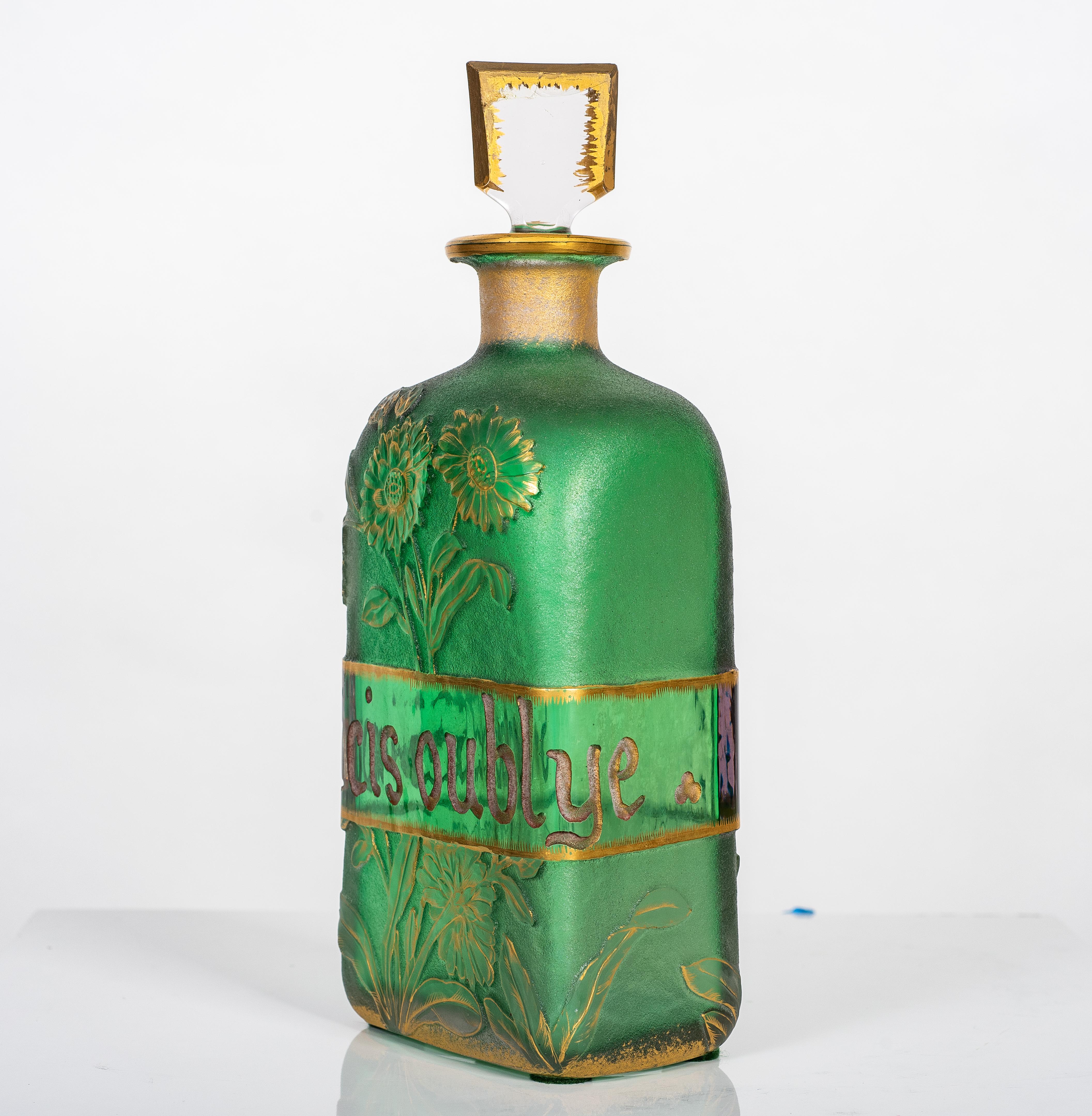 Property of A Private Collector
Fine Daum Nancy Glass Perfume Bottle
France, circa 1910
The diamond shaped bottle, decorated with a full blown iris highlighted with gold on a deep emerald green ground and central band inscribed
'Soucis