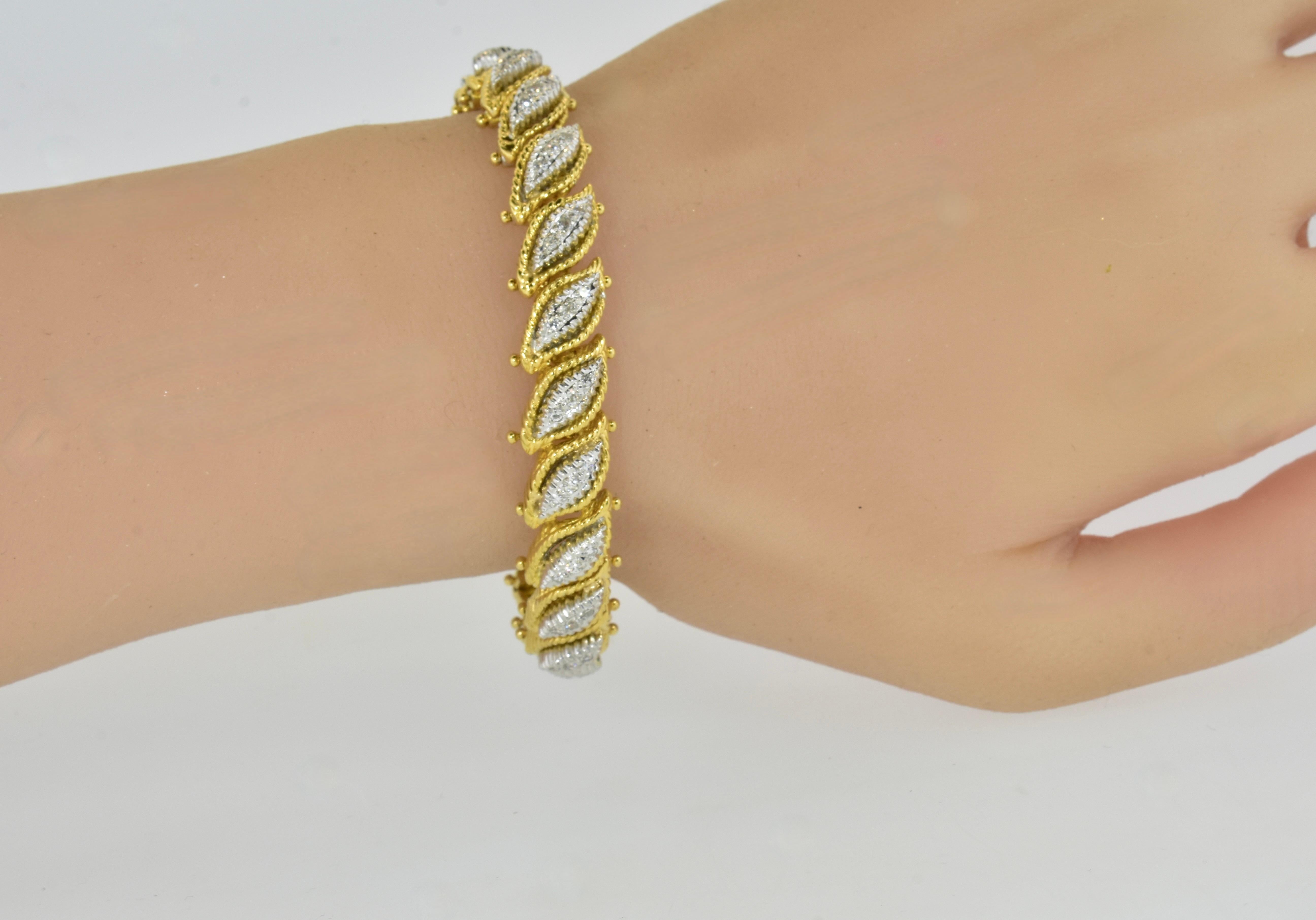 18K yellow and white gold bracelet with diamonds.  This elegant bracelet is hand made, weighs 48.9 grams or 31.44 dwts or 1.57 troy ounces.  There are 21 quite sturdy links which results in a length of 6-7/8ths inches and a width of 3/8th inches. 