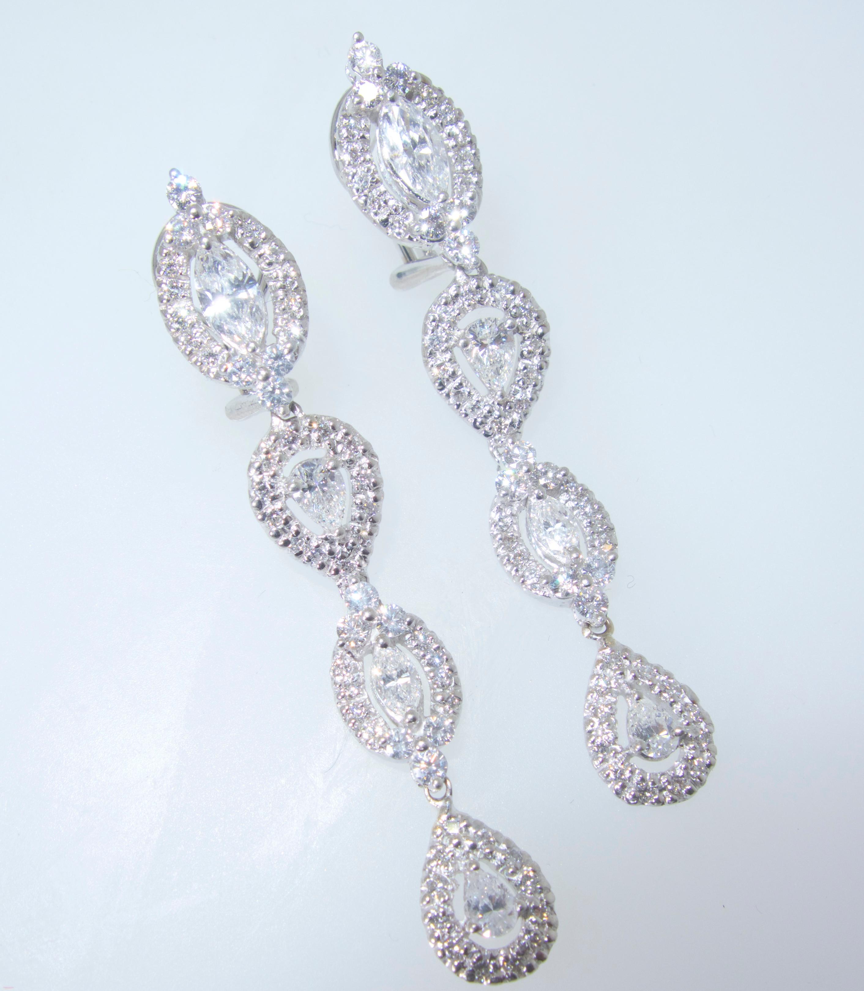 These drop earrings possess fine white diamonds - all well matched, well cut and very white (G/H,VS).  There are approximately 3.2 cts. of round, pear and marquis cut diamonds set in 18K white gold.  These earrings are two inches long.   They can be