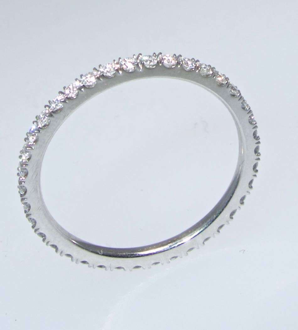 Thin and discreet and easily wearable with almost any diamond ring - or by it's self, this band has .40 cts. of fine white diamonds.  This band is a size 6.25.  As mentioned this is very thin and required a microscope to set the small white