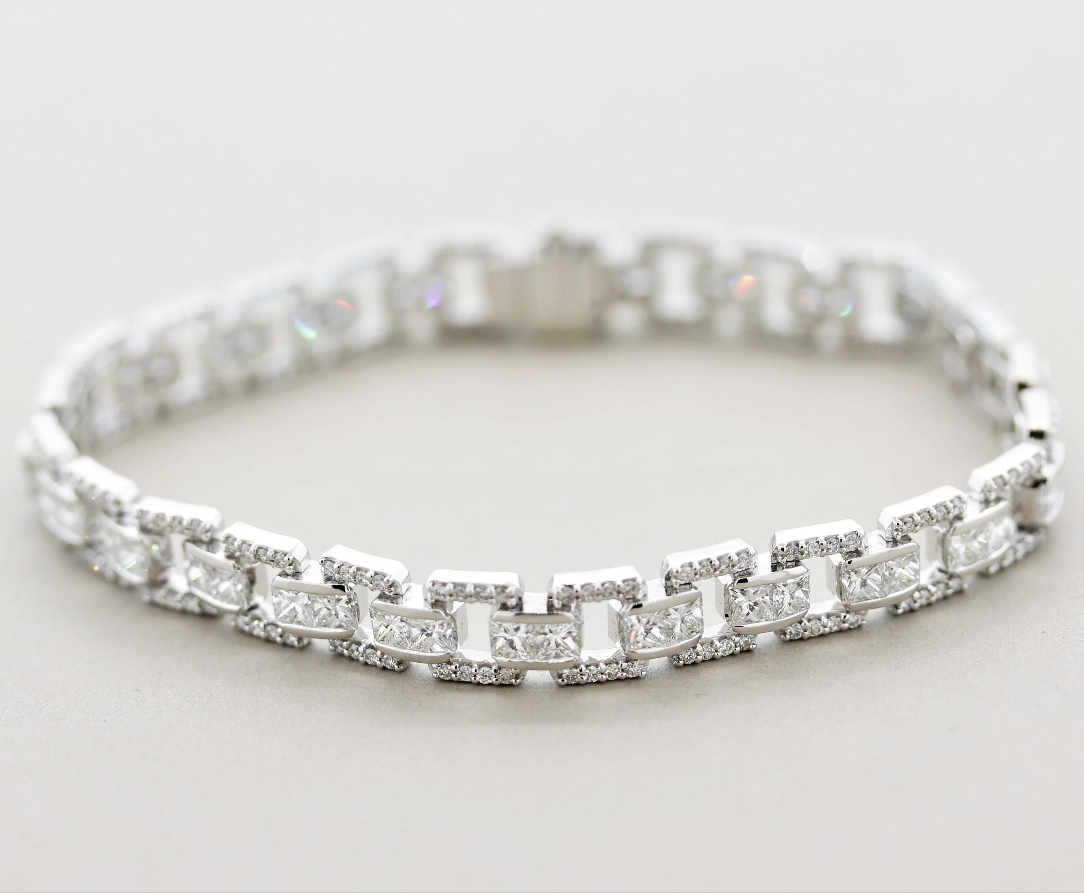A superb diamond bracelet featuring round brilliant-cuts as well as larger princess-cut diamonds. The round-cut diamonds are set on the outside of the bracelet while the larger princess-cuts are set in pairs in the center of the chains. Diamonds are