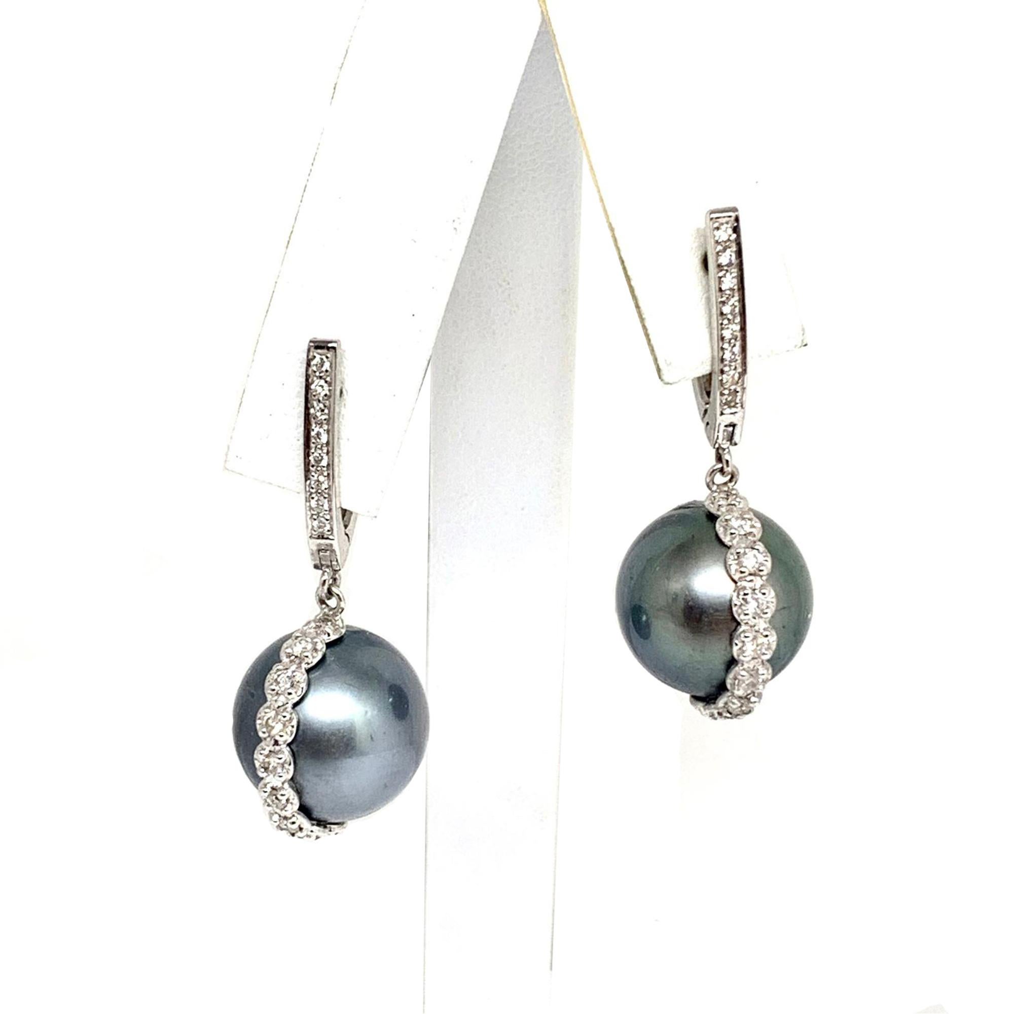 Certificate#201915538 WG

Certified Authentic Tahitian Saltwater Pearl Large 14.05-13.90 MM appx and Diamond 14KT White Gold Earrings with a total weight of 11.33 Grams 

This is a One of a Kind Unique Custom Made Glamorous Piece of