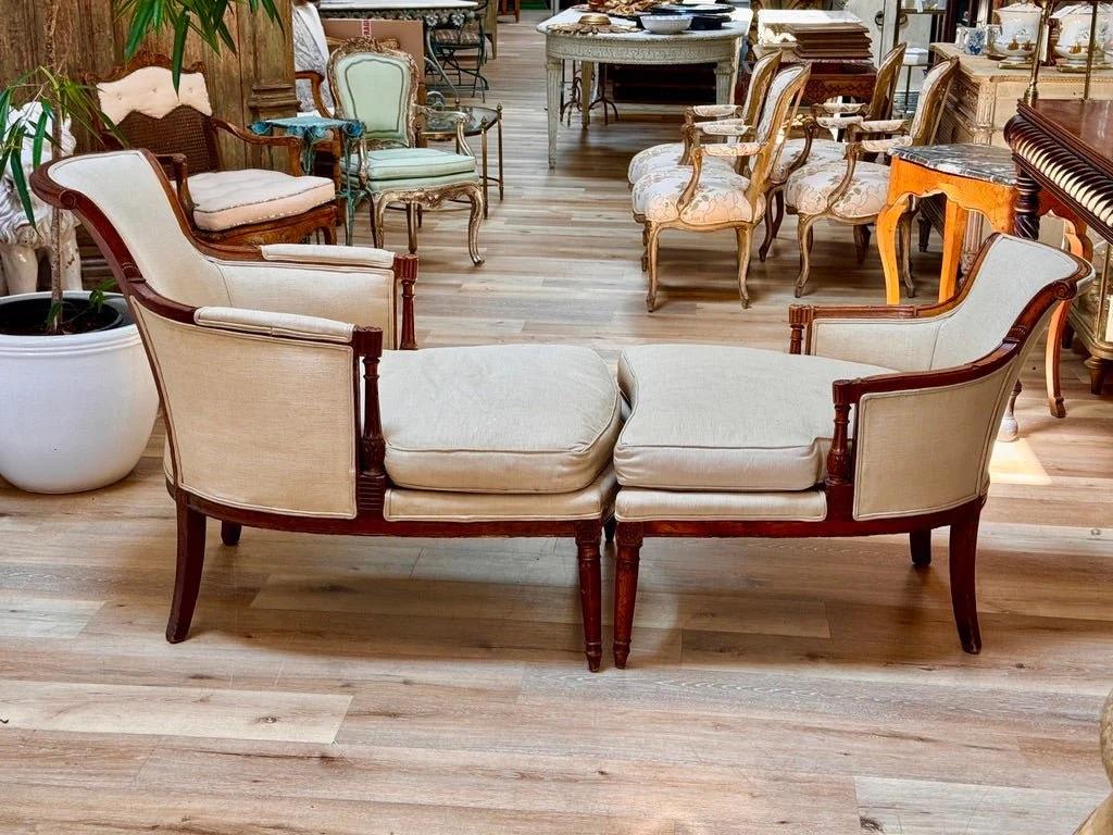 Fine Duchesse Brisée, or recamier, French, Directoire, c. 1800.  Comprising two  bergères, this form emerged in the late 18th century as a modular chaise alternative. Carved mahogany frame with fluted legs and paneled sides. A refined example of the
