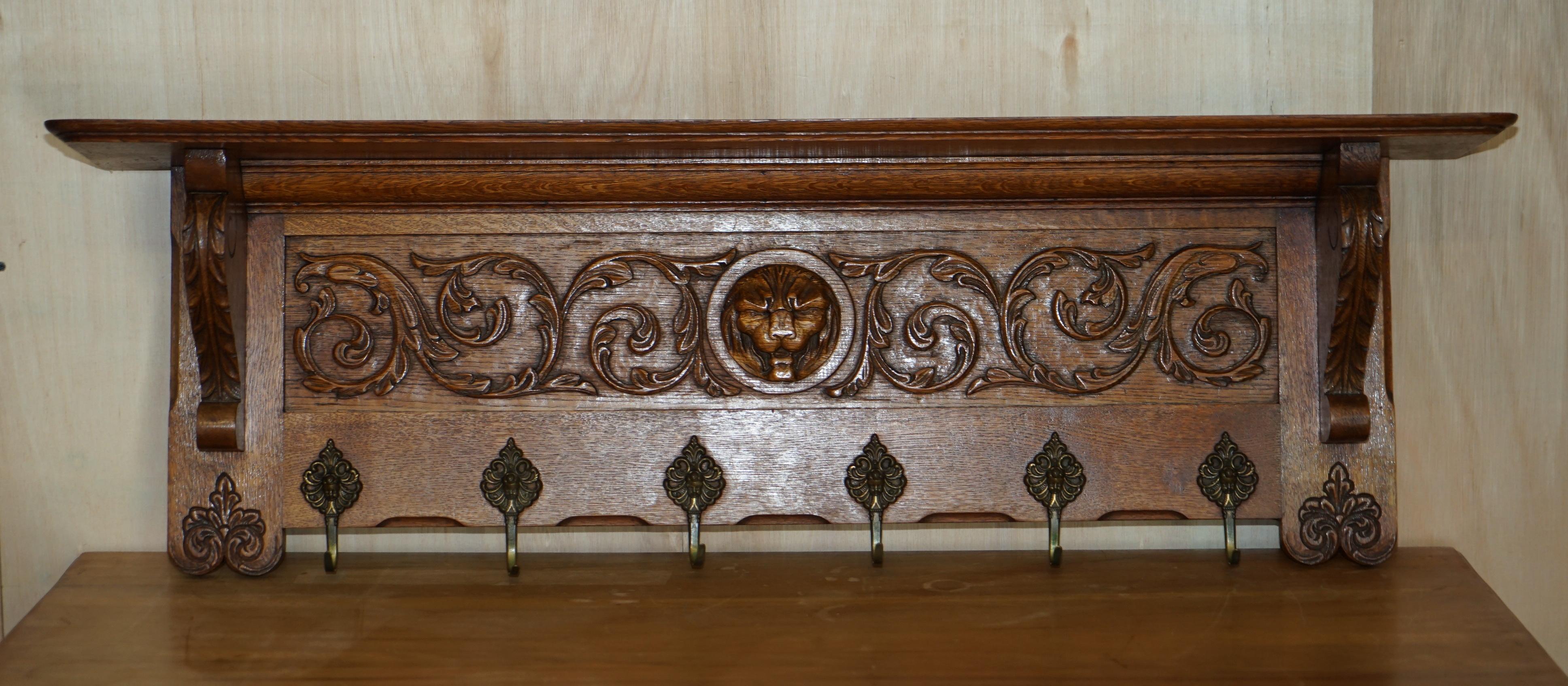 We are delighted to offer for sale this lovely, heavily carved Dutch oak wall hanging coat hat and scarf rack with French Lion's head central carving gold gilt brass hooks

A very good looking well made and decorative coat wall rack, I have seen