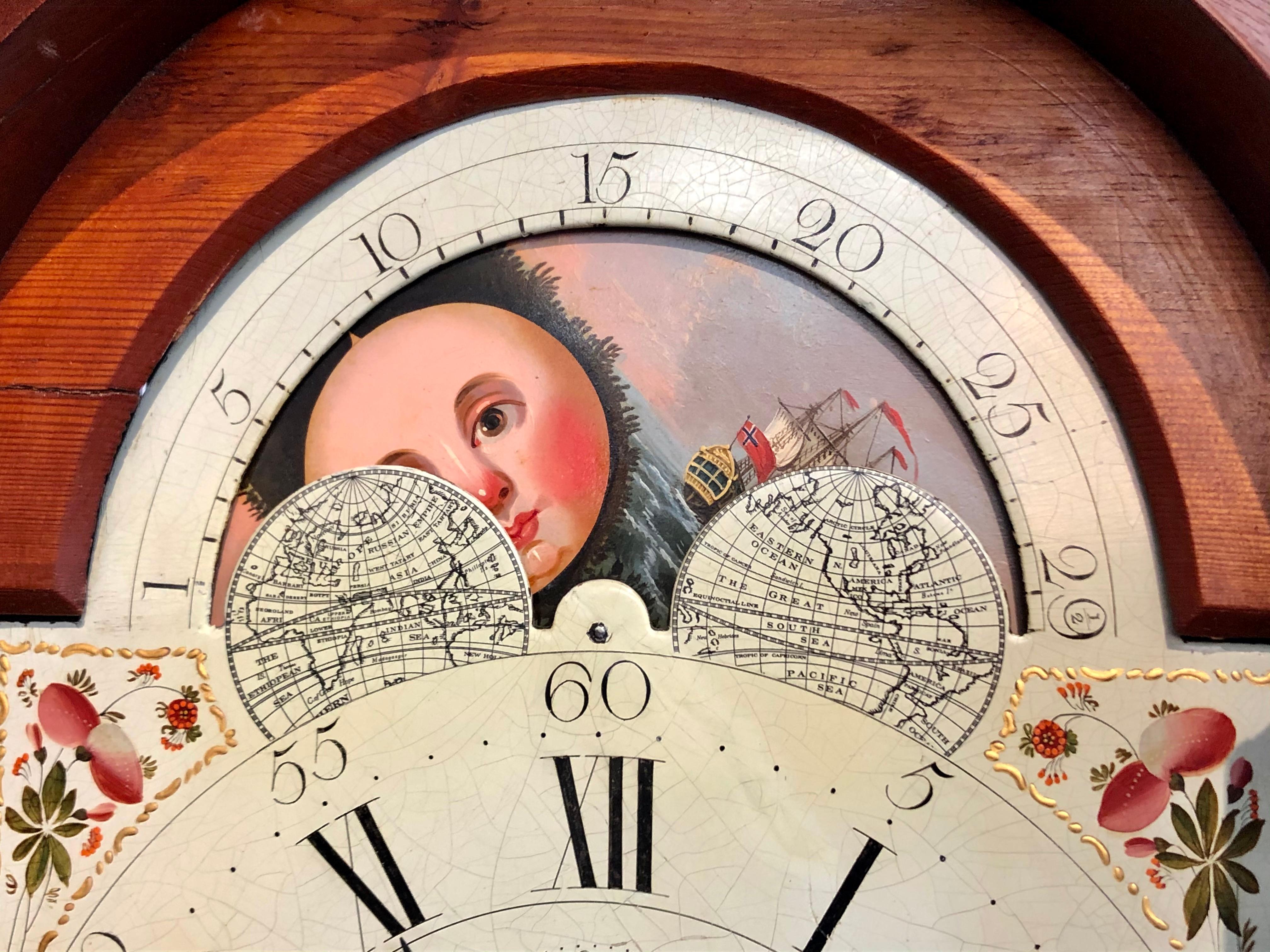 Lovely antique Scottish early 19th century inlaid mahogany painted dial longcase clock with rotating moon phase dial, calendar dial and second hand sweep. Nicely figured case has beautiful inlaid urn and leaf motif on center of waist door. David