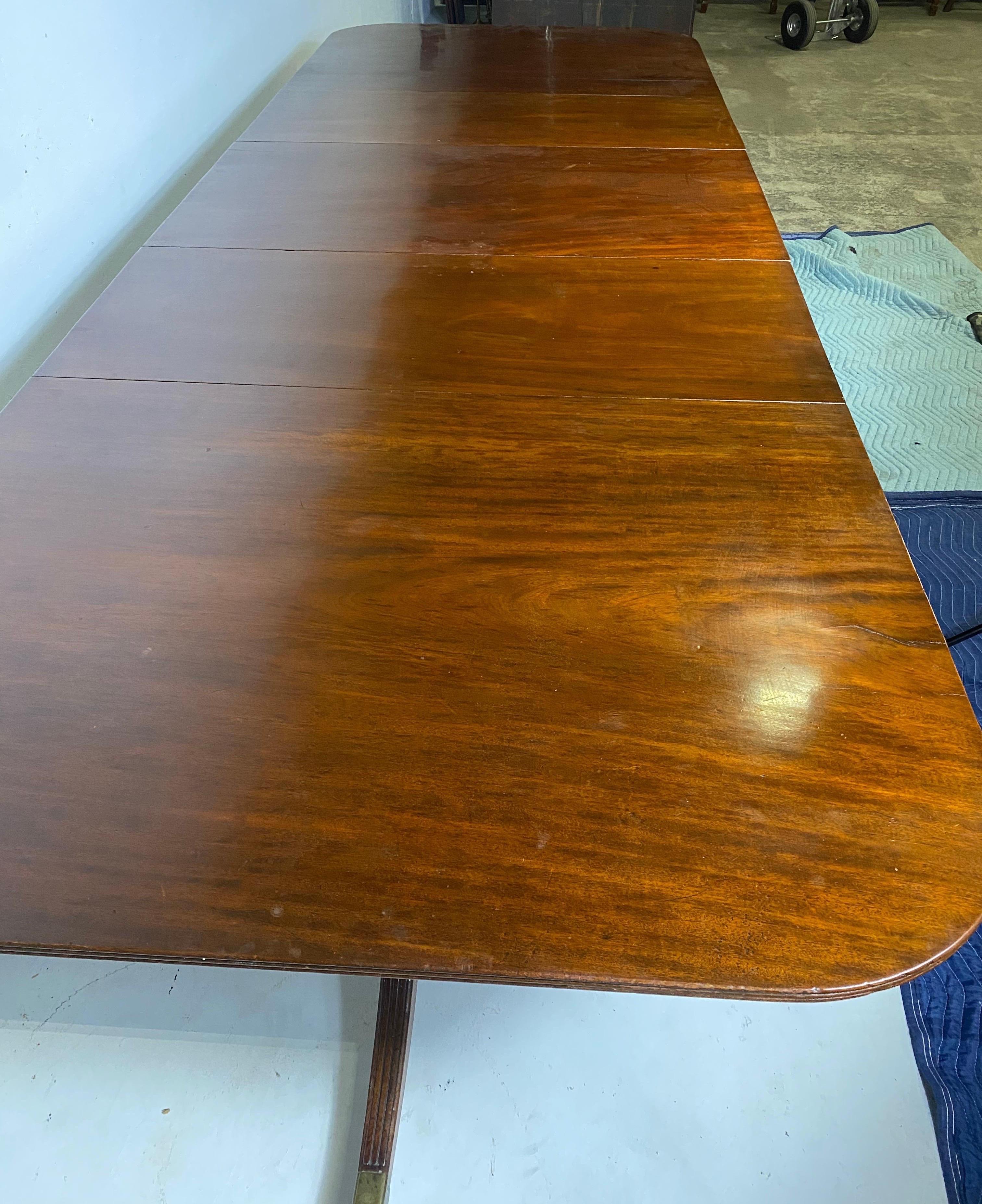 Very fine early 19th century English mahogany triple pedestal dining table with 2 leaves, clips and original castors. Great quality Cuban mahogany. Provenance- from the Massey estate on Monument Avenue, Richmond VA.