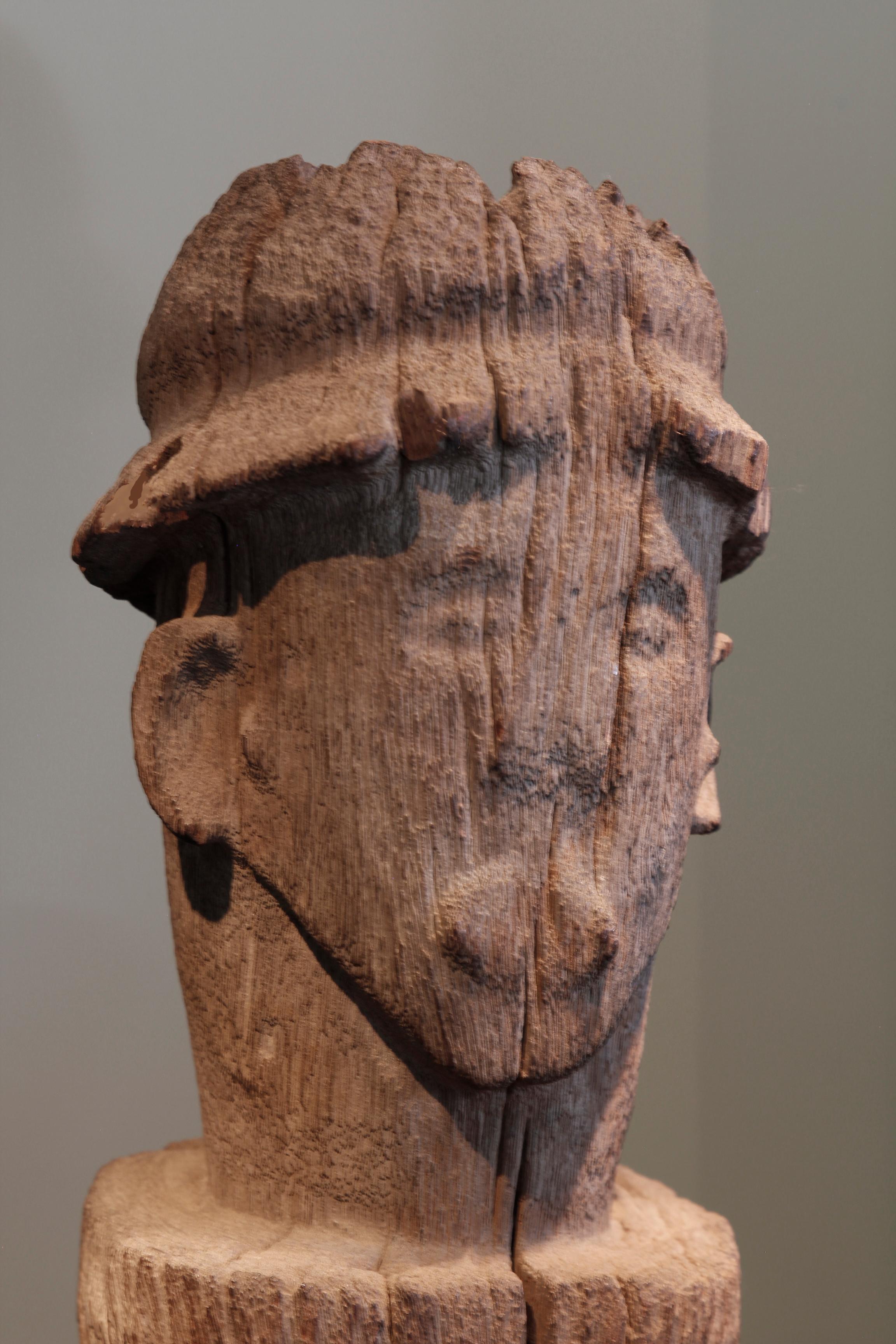 This fine early twentieth-century ancestral post, from the Bongo culture in South Sudan, takes the form of a tall, multiple-ringed column. Carved from a hard wood, the post exhibits a beautiful weathered, worn and bleached surface. Surmounting the