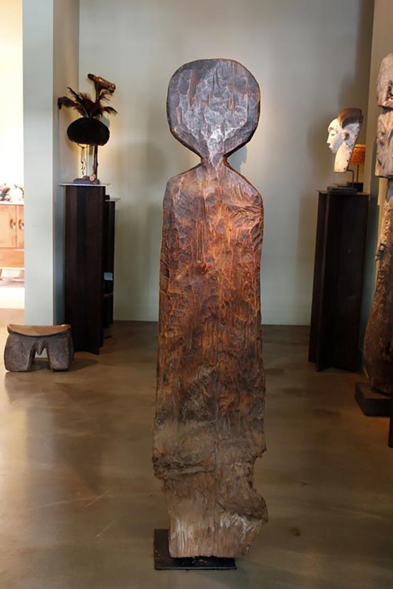 Carved from a hard, heavy wood, this early twentieth-century Gurage house post from Ethiopia has developed a beautiful, rich surface patina as a result of touching and handling over time. 

Posts, or markers, such as this would have been placed