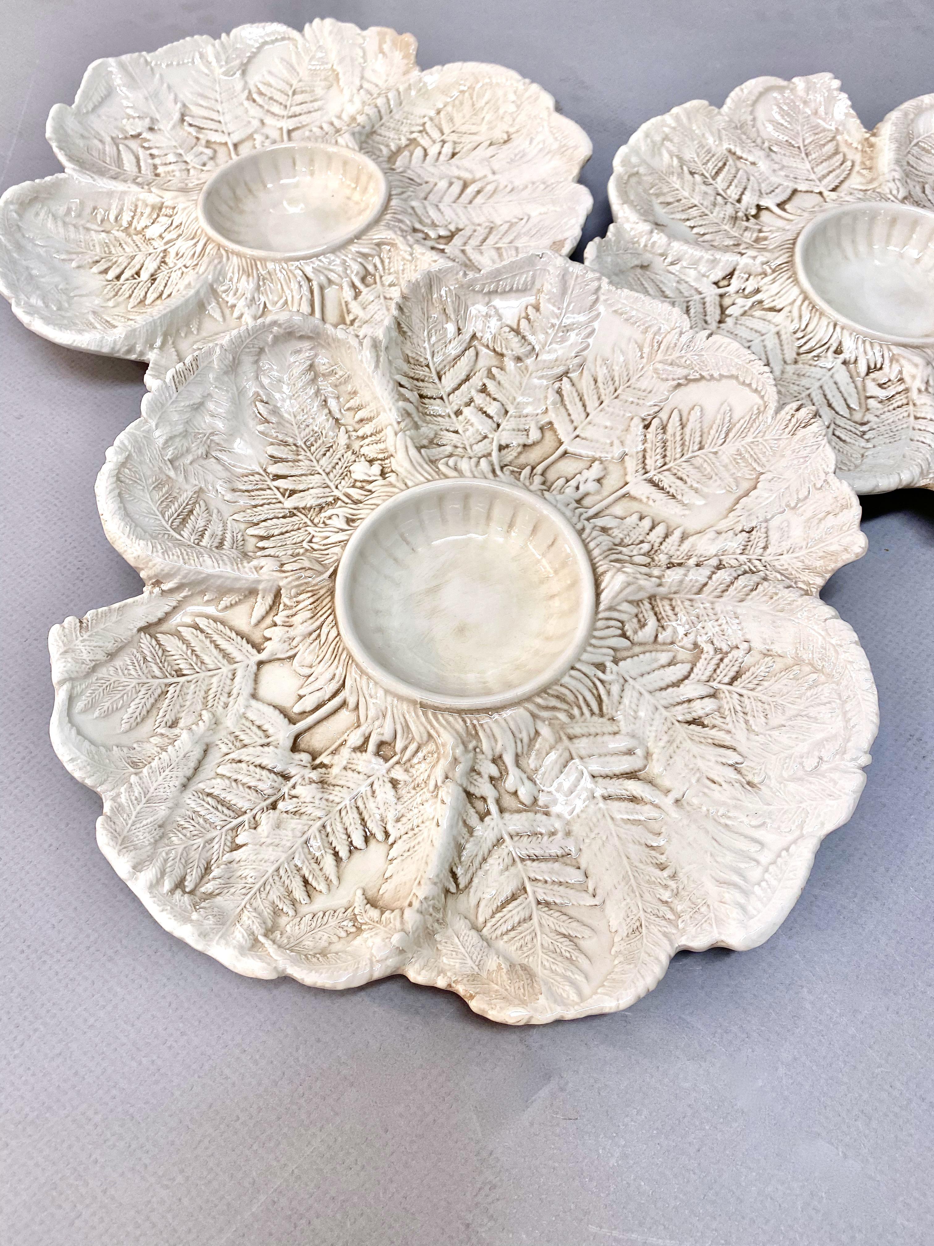 This is an unusual set of 12 early to mid 20th century artichoke plates that are finely designed with a raised incised fern leaf pattern. The raised leaf pattern is highlighted by a pale sienna wash. The plates have no apparent faults, although