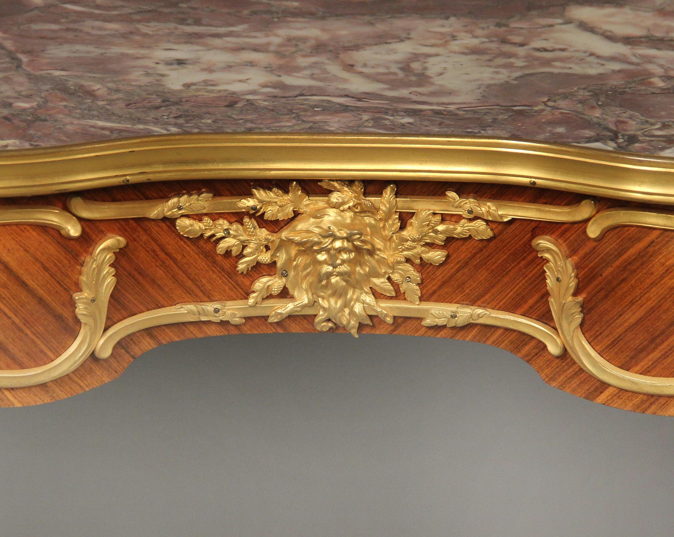 Fine early 20th century gilt bronze mounted Louis XV style side/writing table by François Linke

François Linke – Index Number 49

The shaped rectangular fleur de pecher marble top, above a serpentine frieze with foliate-cast frame, the front