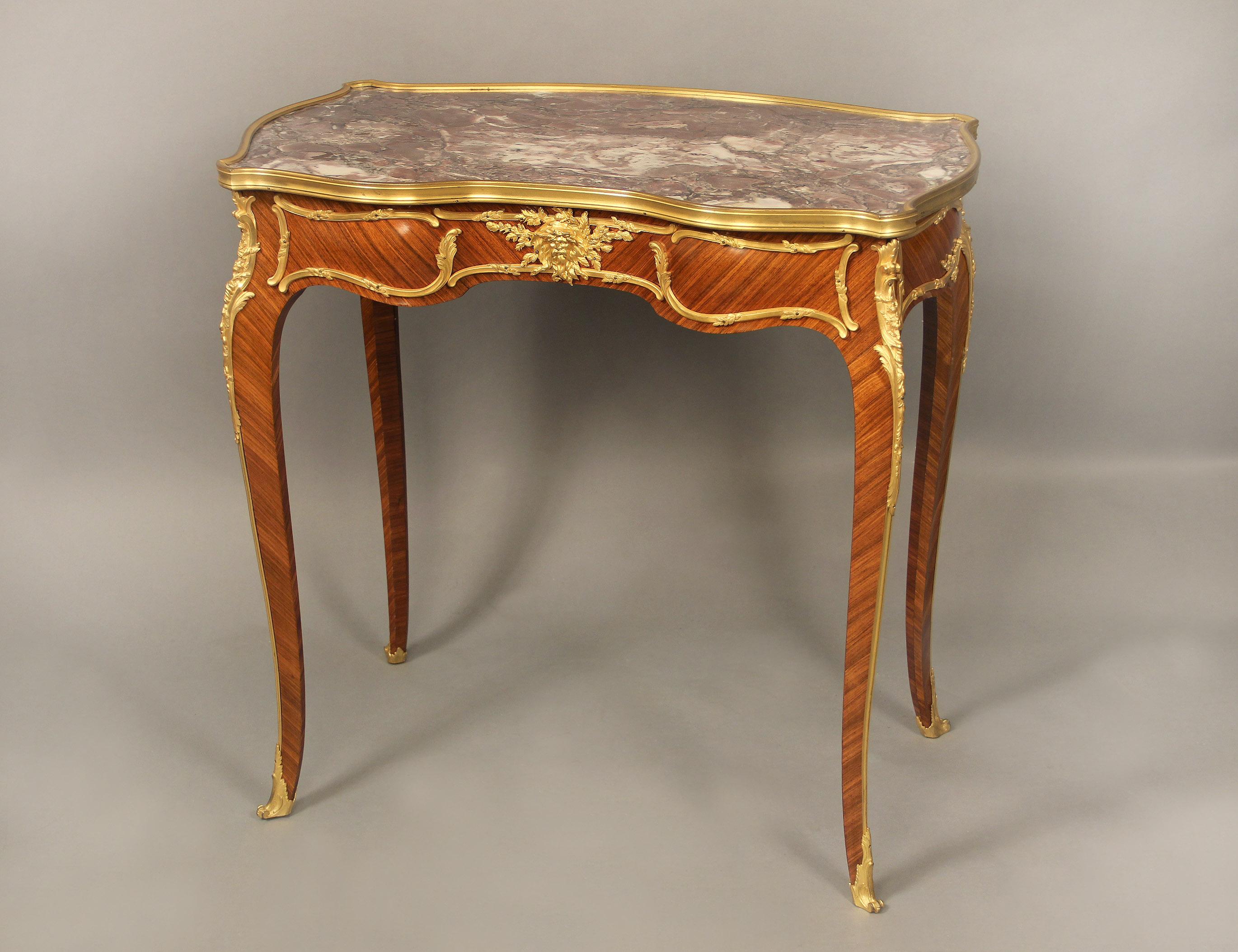 Fine early 20th century gilt bronze mounted Louis XV style side/writing table by François Linke

François Linke – Index Number 49

The shaped rectangular fleur de pecher marble top, above a serpentine frieze with foliate-cast frame, the front fitted
