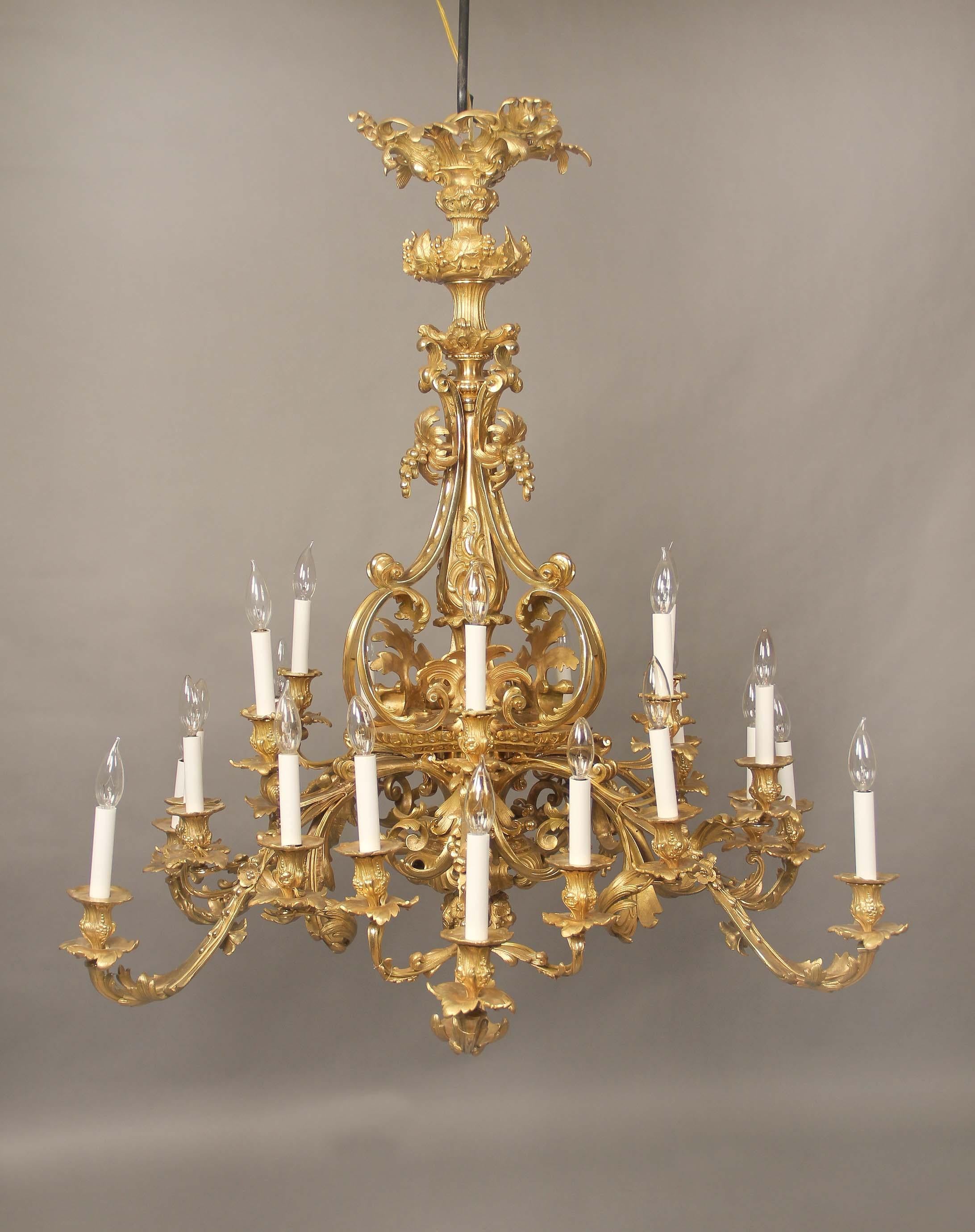 A fine early 20th century gilt bronze twenty-four light chandelier.

The all bronze chandelier with a central floral stem with foliage and fruit designs along the body and arms, twenty four long branch tiered perimeter lights.

If you are