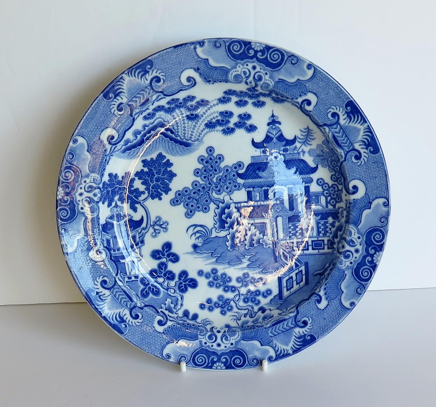 This is a beautiful early plate in a printed blue and white chinoiserie pattern and made of a type of earthenware pottery called Pearl-ware, in the very early 19th century by the Spode factory, circa 1805.

This plate is made of Pearlware