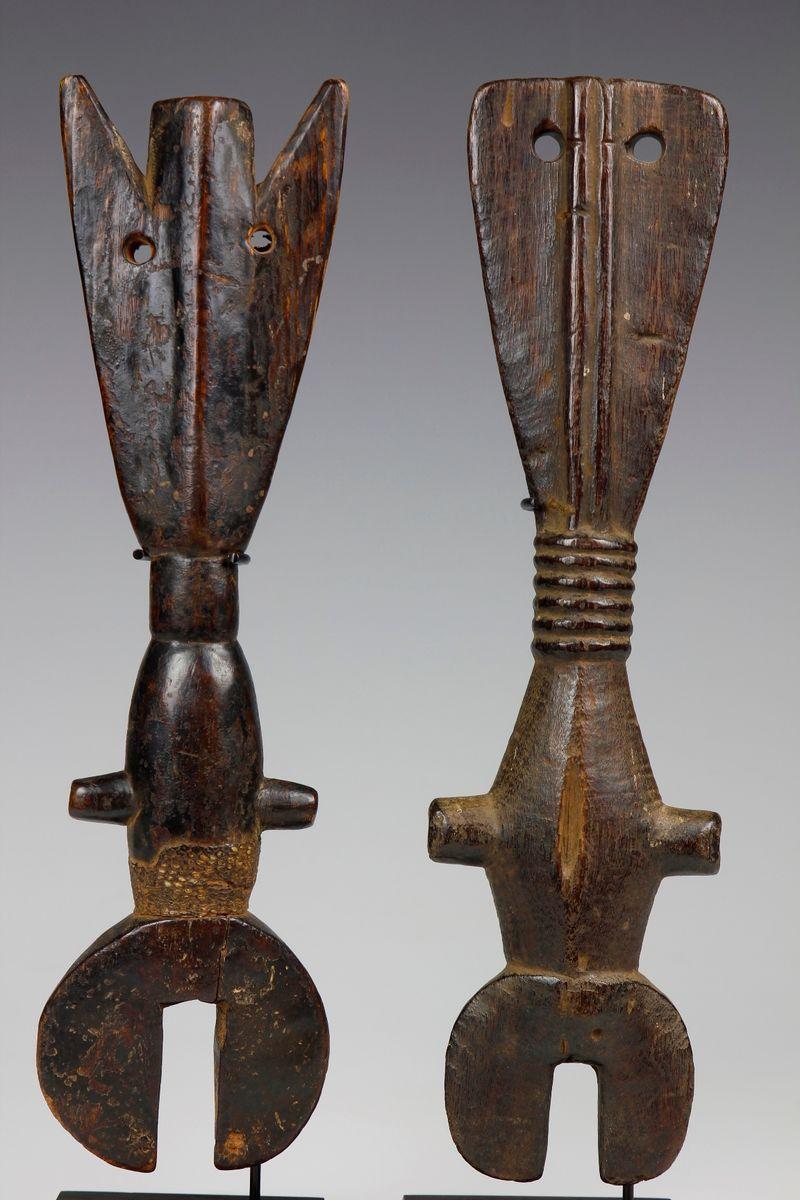 Together, these two finely carved flutes display a wonderful interplay of the abstracted forms of a 'male' and 'female' figure.  A strip of snake skin has been wrapped around the 'body' of the 'male' figurative flute, located to the left in the