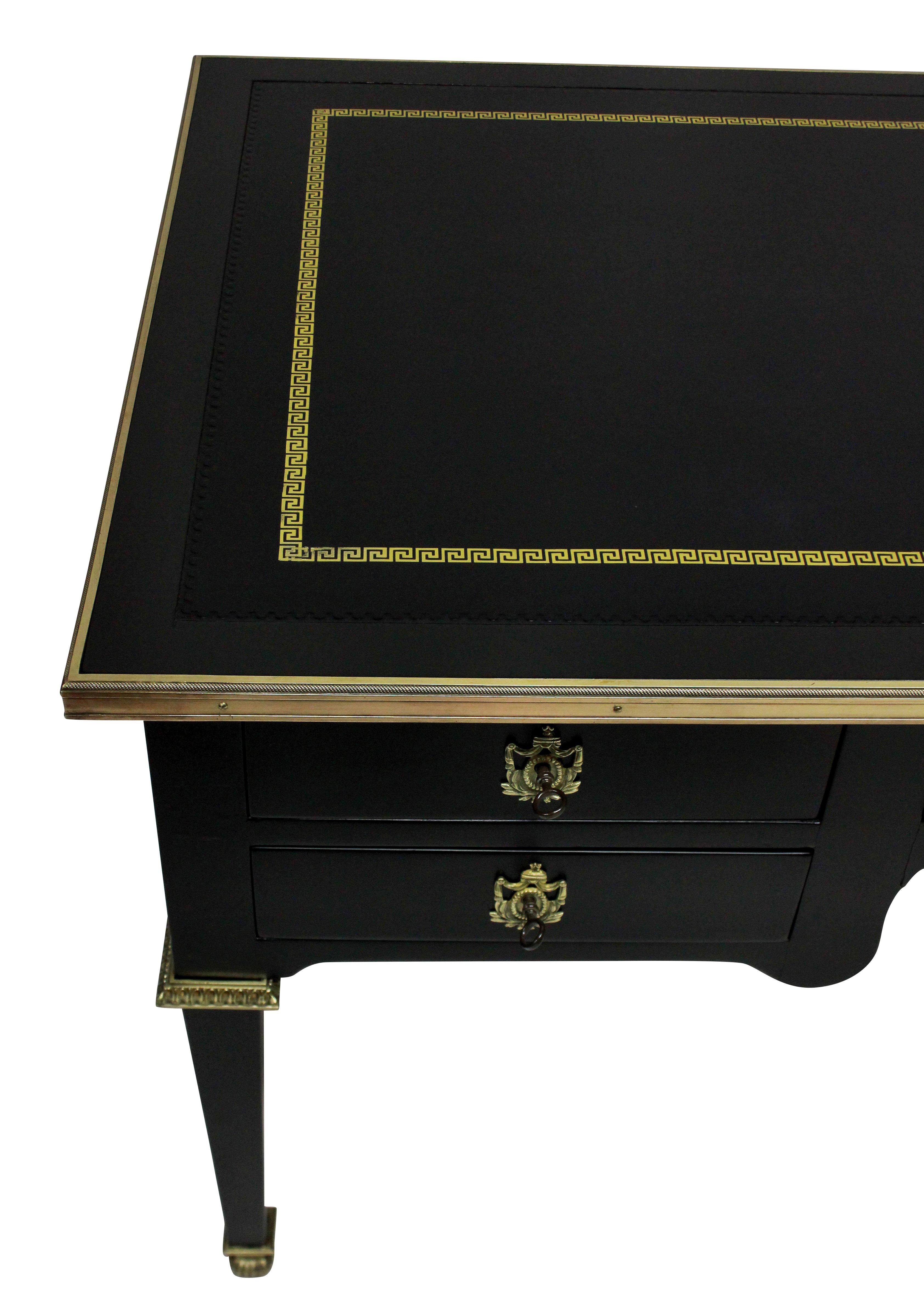 A fine French Louis XVI style desk in ebonized walnut with a leather top with Greek key border. The gilt bronze mounts and escutcheons of good quality and each drawer have a separate key.
Measures: 57 cm high knee hole.
 