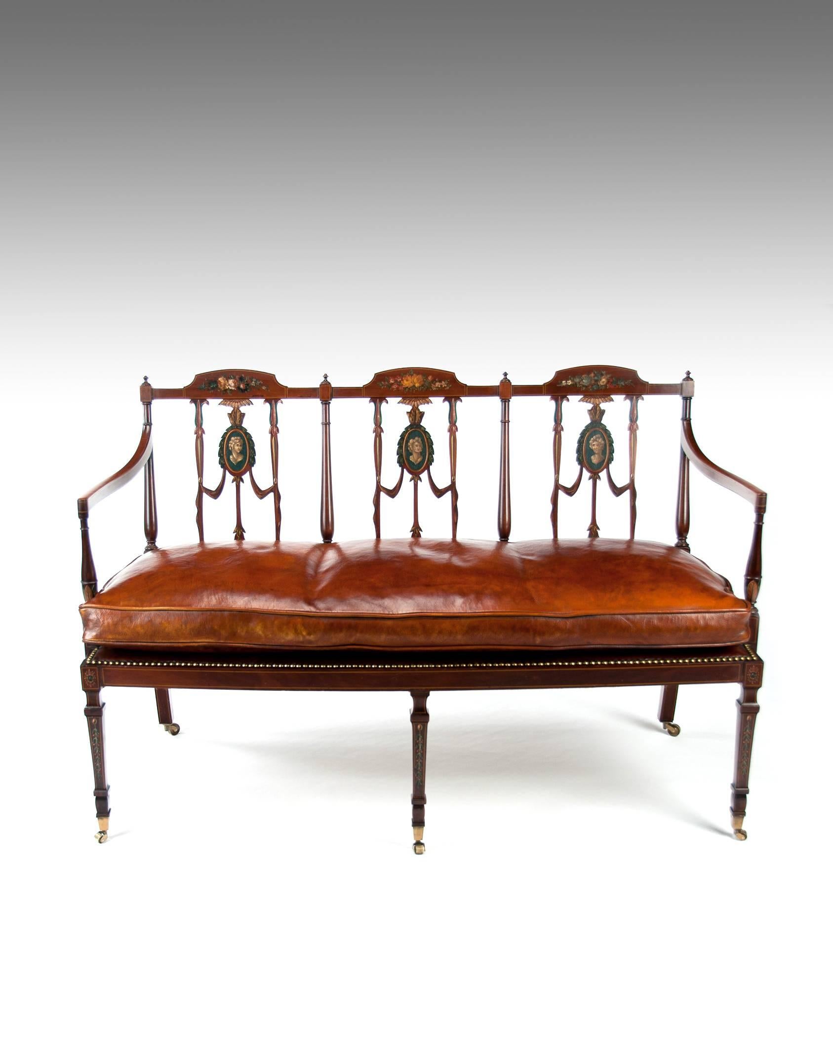 A fine quality Edwardian inlaid and painted mahogany settee / seat with a leather upholstered cushion seat.
Of neoclassical design the shaped back being painted with three medallions of classical Roman figures surrounded by floral design and