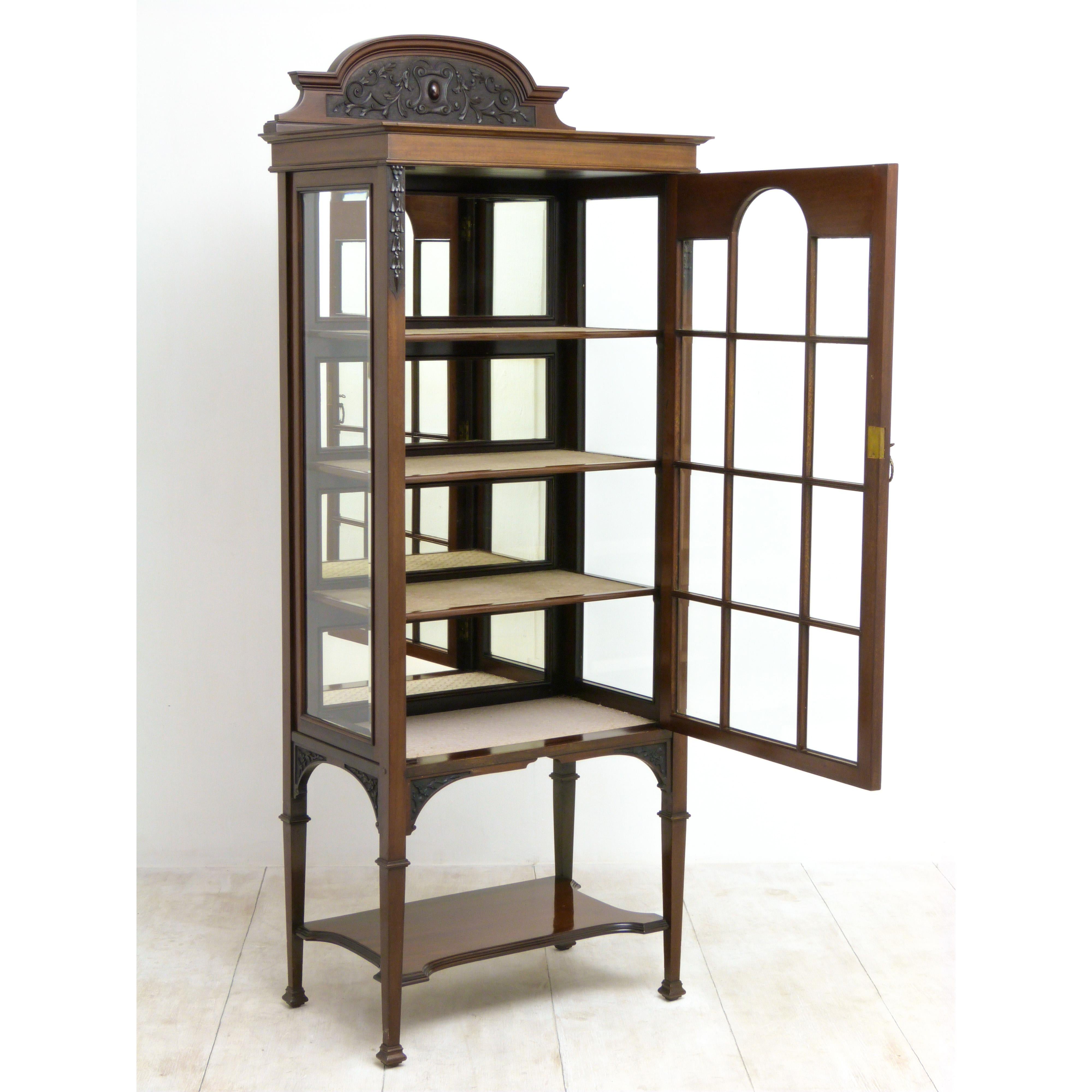 A fine quality Edwardian display cabinet of unusual proportions, circa 1905. Tall and slim, it is made from mahogany with bevel glazed windows front and sides. The carving is of exceptional quality. The condition is very good and original right down