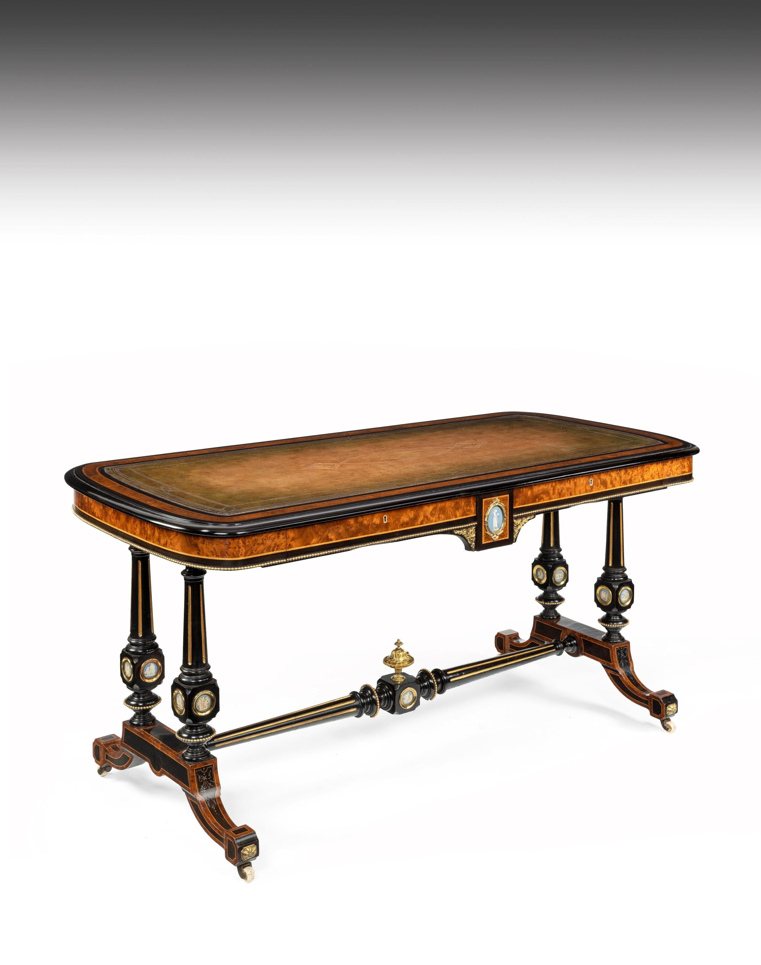 A very fine well sized ebonized and thuya wood writing table / library table decorated with blue wedgewood jasper ware plaques, stamped to the drawer ‘Edwards and Roberts, London.’

English, circa 1850. 

Of excellent proportions, the large