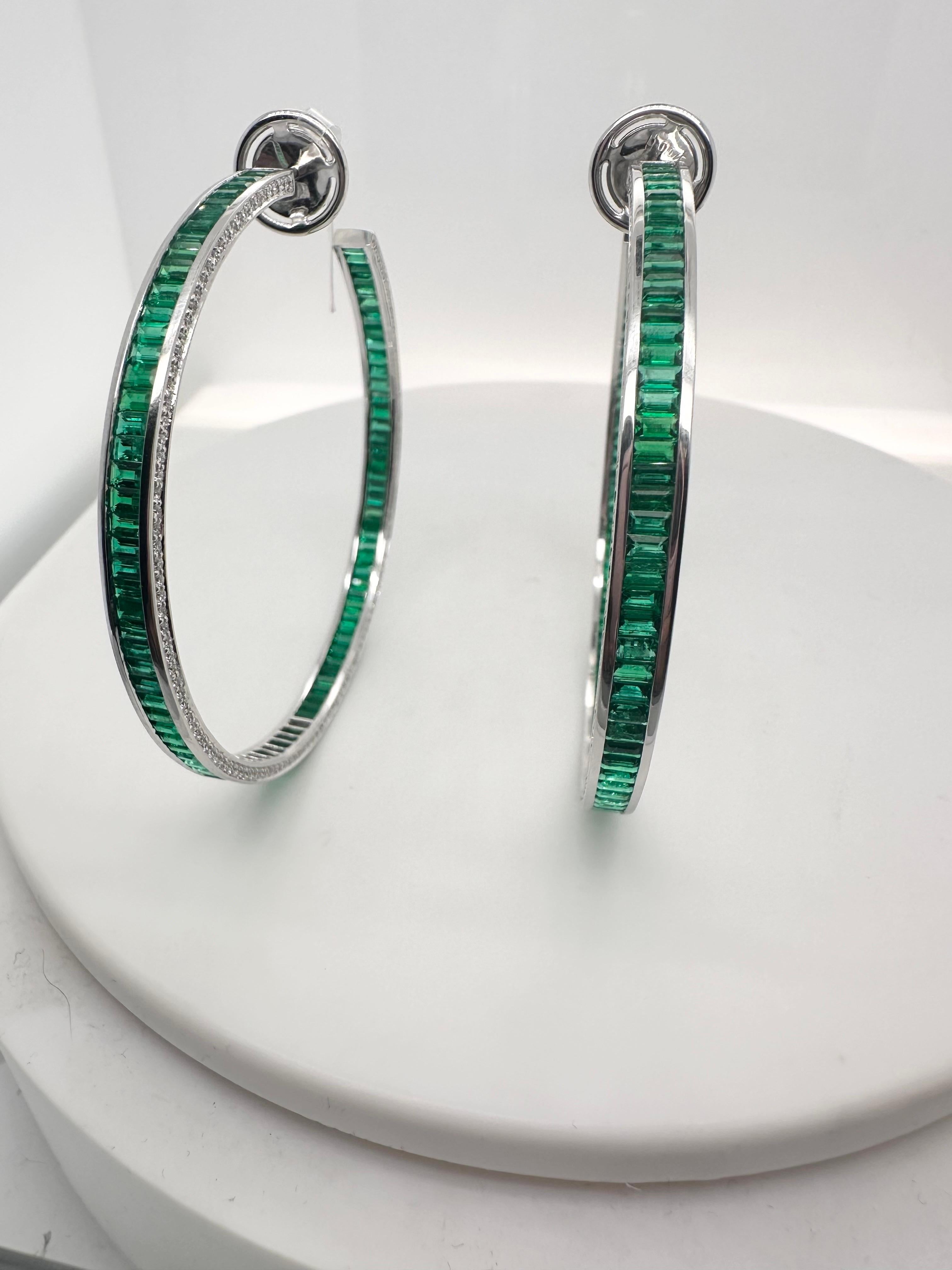 Exquisite earrings made with so many details and exceptional craftsmanship, Colombian emeralds, fine quality green emeralds with natural fine diamonds in a fancy hoop design! Even the butterfly has diamonds! These earrings are super rare as they