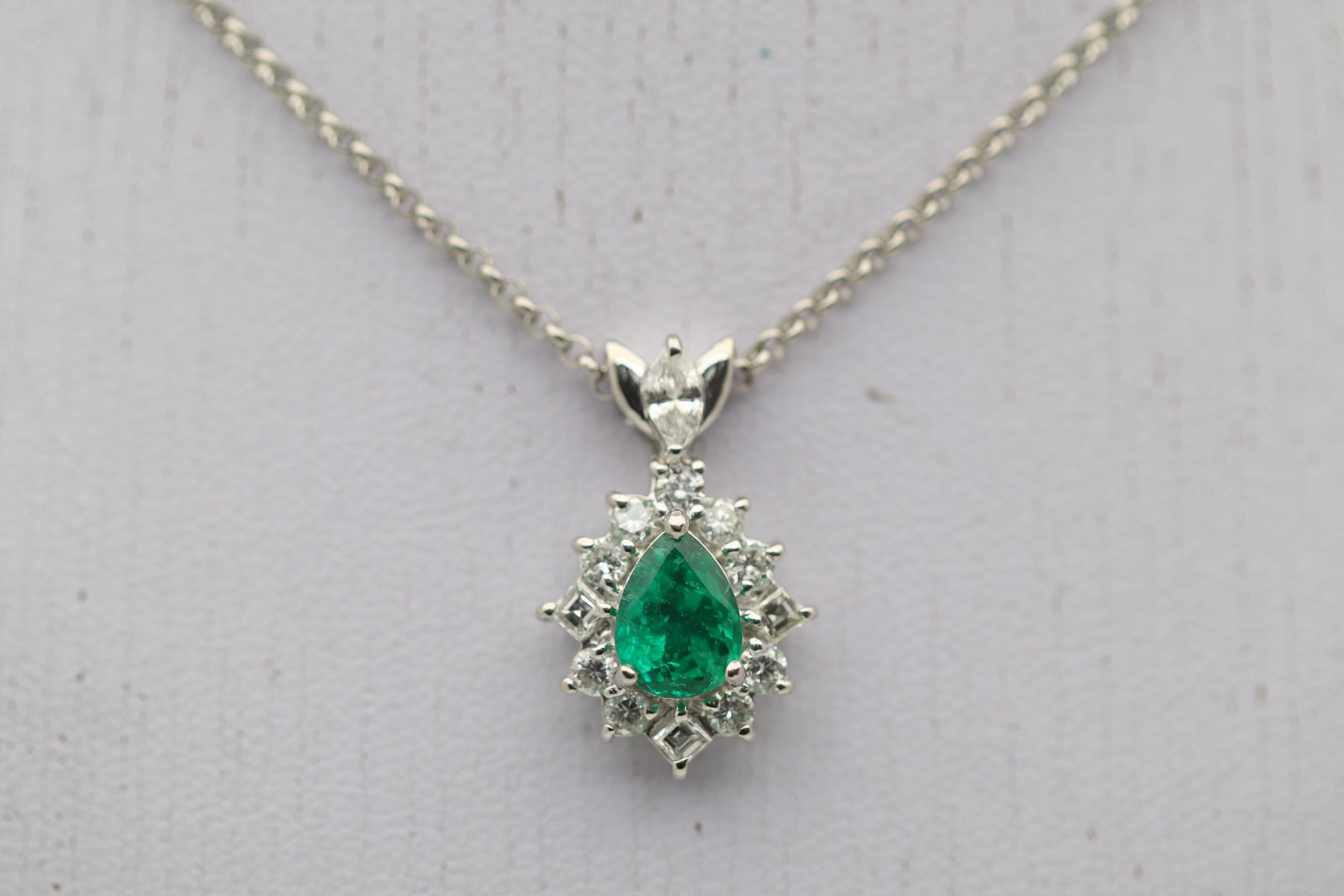 A very fine quality emerald takes center stage of this platinum made pendant. The emerald weighs 1.11 carats and has a rich vivid green color with excellent brightness and light return. The color is close to the finest an emerald can be. It is