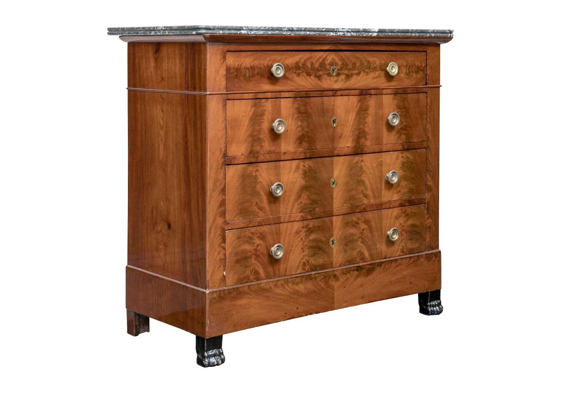 A fine diminutive Empire Chest dating to the 1st half of the 19th Century in original condition. The Chest with book matched flame mahogany drawer fronts with great color, refined round brass drawer pulls with delicate incised design, dove-tail