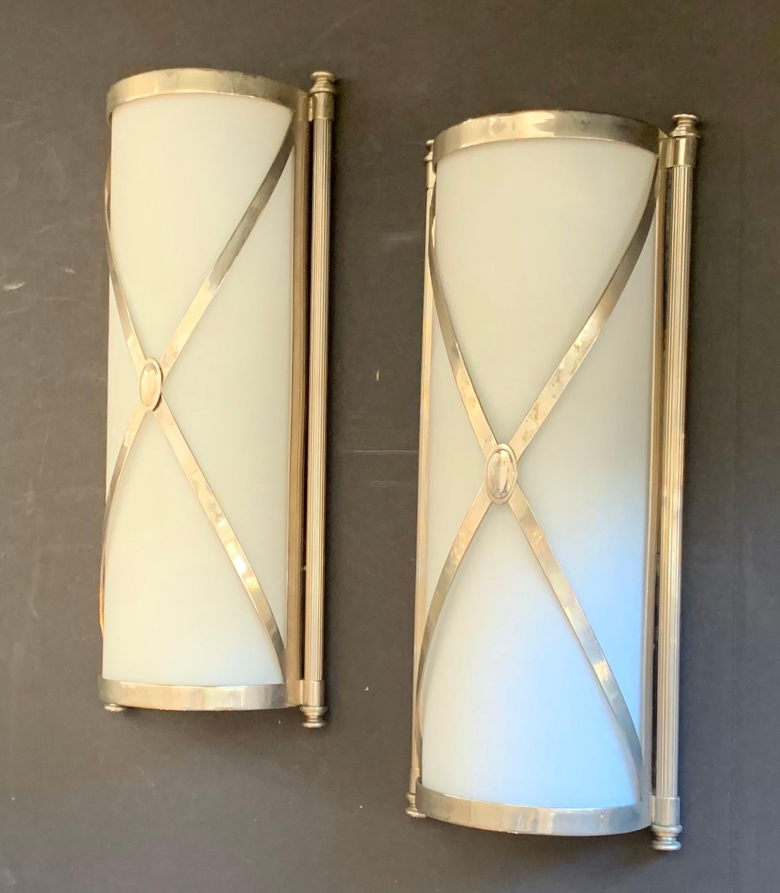 A wonderful pair of Empire / neoclassical silvered bronze and frosted glass Caldwell style sconces each with 2 Edison bulbs rewired to work in damp spaces.