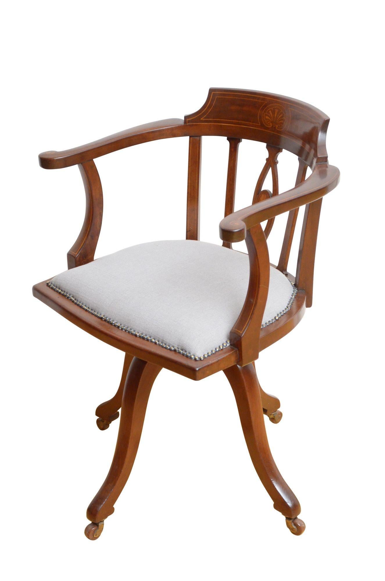 K0605 Fine quality and very elegant Edwardian solid mahogany swivelling office chair, having sting and shell inlaid top rails, shaped and string inlaid arms and closely studded serpentine seat with new grey top cover, all standing on slender