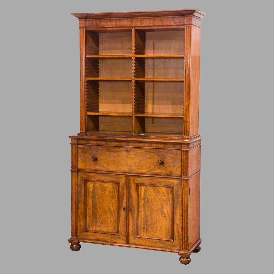 A beautifully crafted late Regency mahogany secretaire bookcase in 2 parts, made and signed by Gillows of Lancaster, one of England's finest cabinetmakers for over 200 years. The piece has a projecting molded cornice over an open bookcase upper