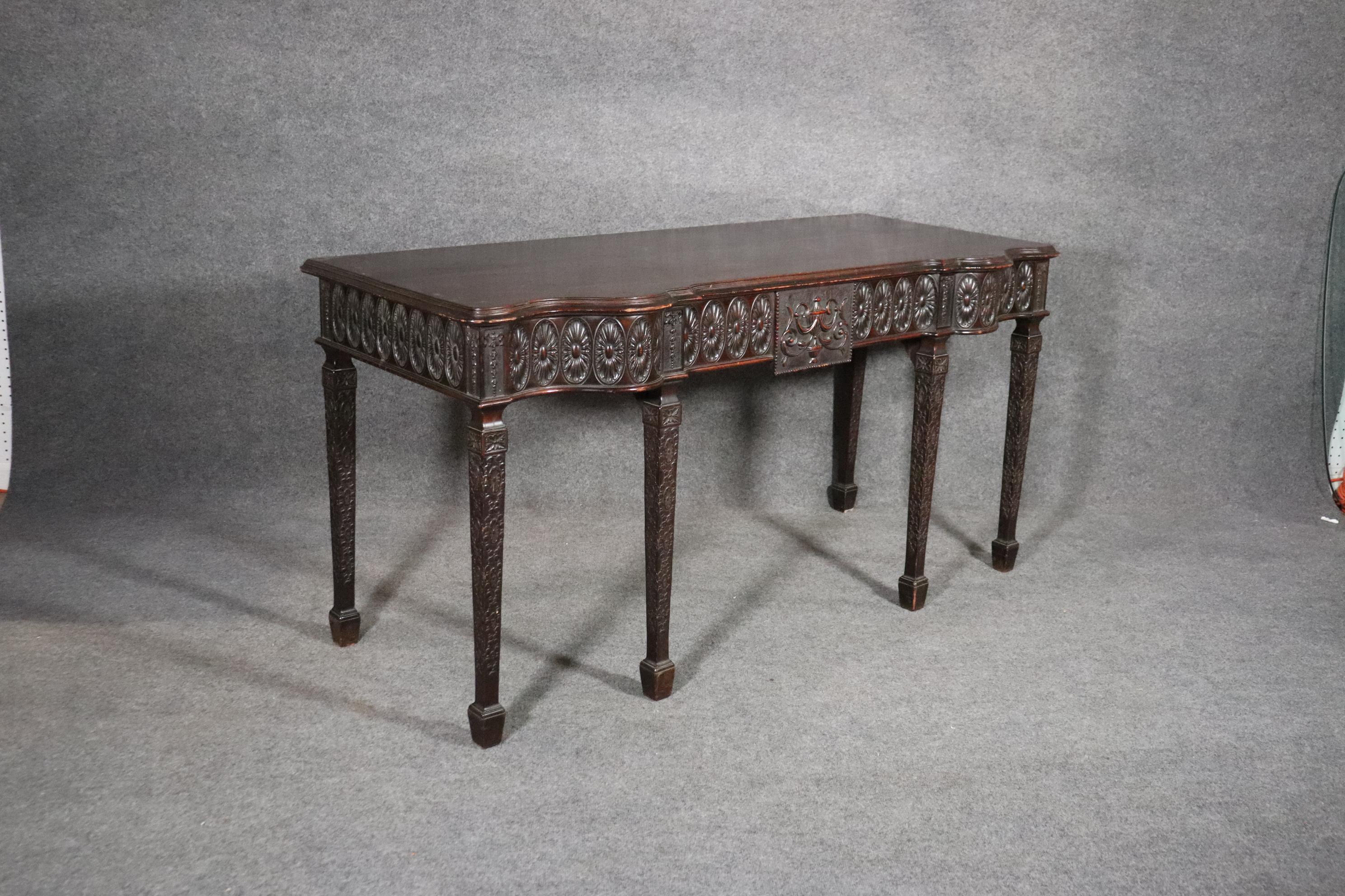 This is a superb quality English Buffet or Huntboard that can also be used as a console table. The table features that beautifully balanced design that Adams is known for and the carving is spectacular. The foreground carving is crisp and bold and