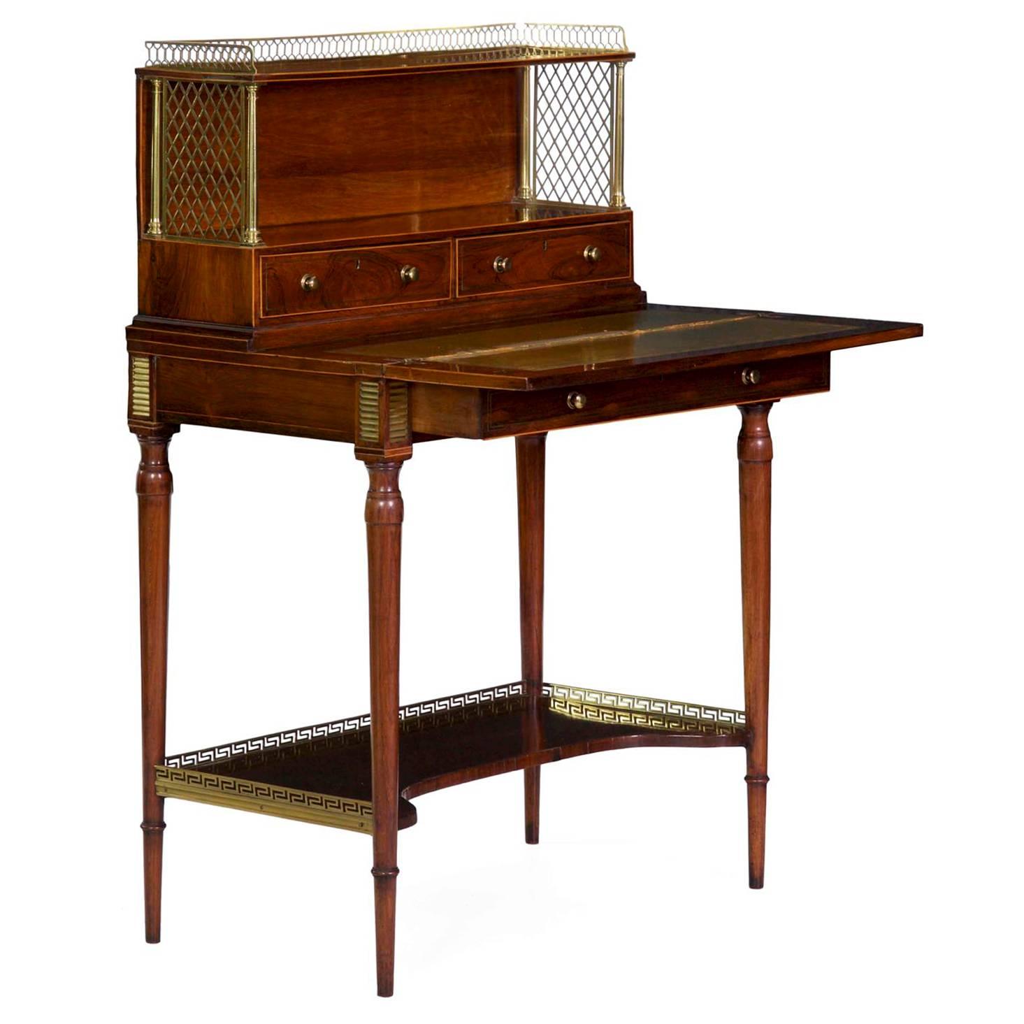 This Regency period writing desk is of exceedingly exact craftsmanship, precise in joinery and design, a very finely made piece by every measure.  It is designed in the French taste, an English creation inspired by contemporary works in the Louis