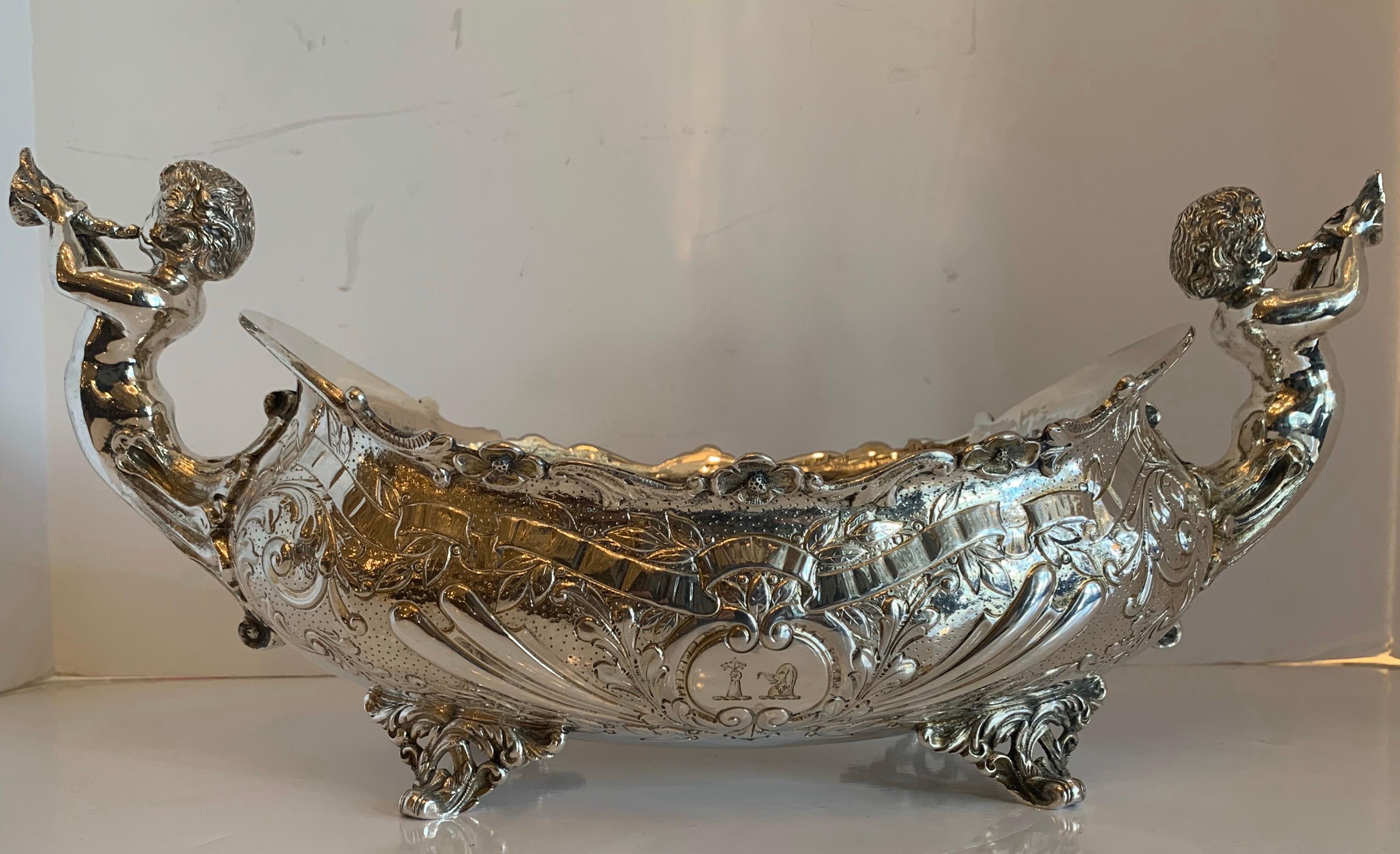 A Fine English Sterling Silver With Hallmarks, Cherub / Putti Horn Playing Blowing Handle Large Footed Centerpiece
17