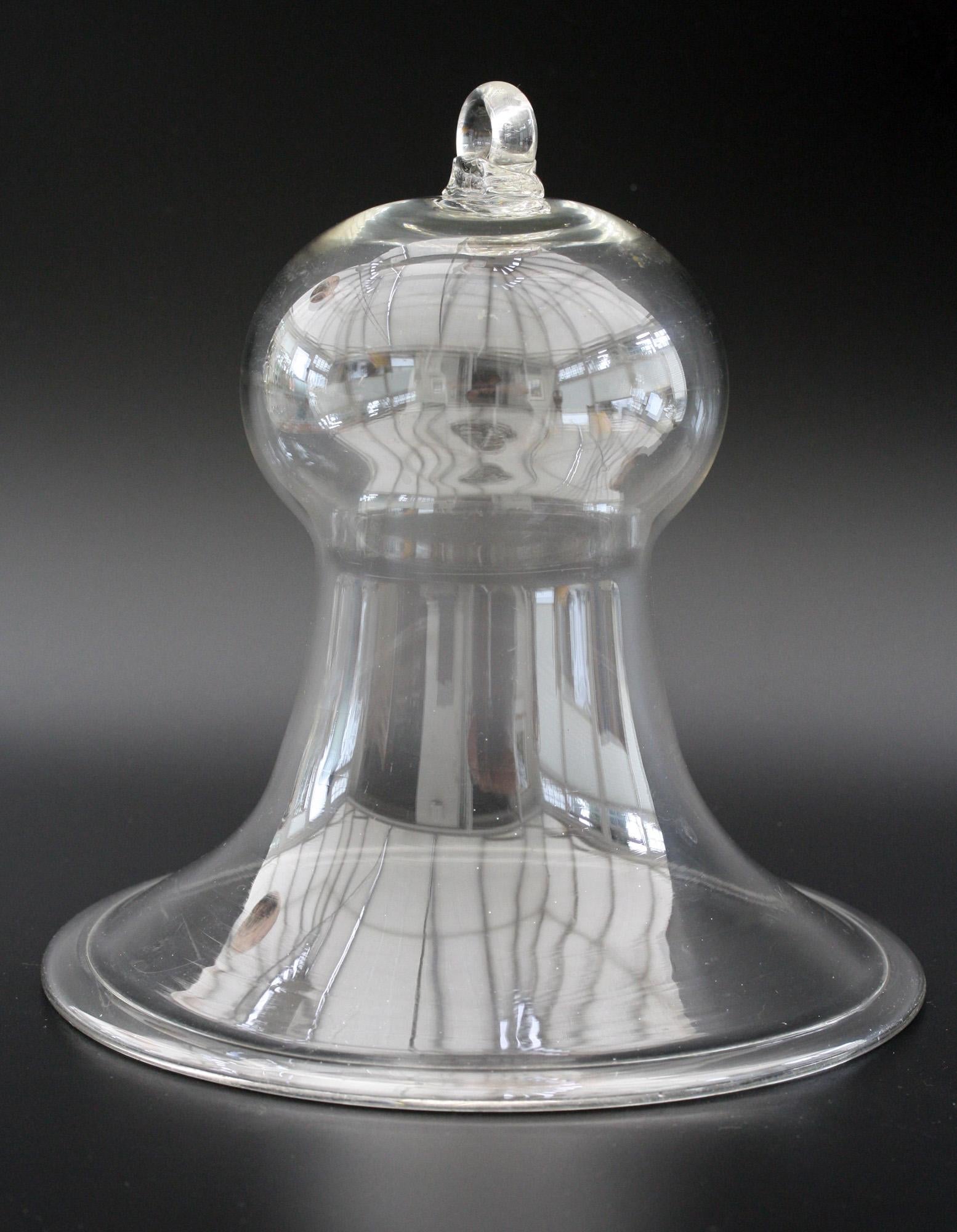 A fine English early Victorian clear glass smoke bell probably dating from circa 1850. Used to capture the smoke from oil lamps the bell would be hung suspended from the ceiling above the oil lamp preventing the smoke for dispersing and causing