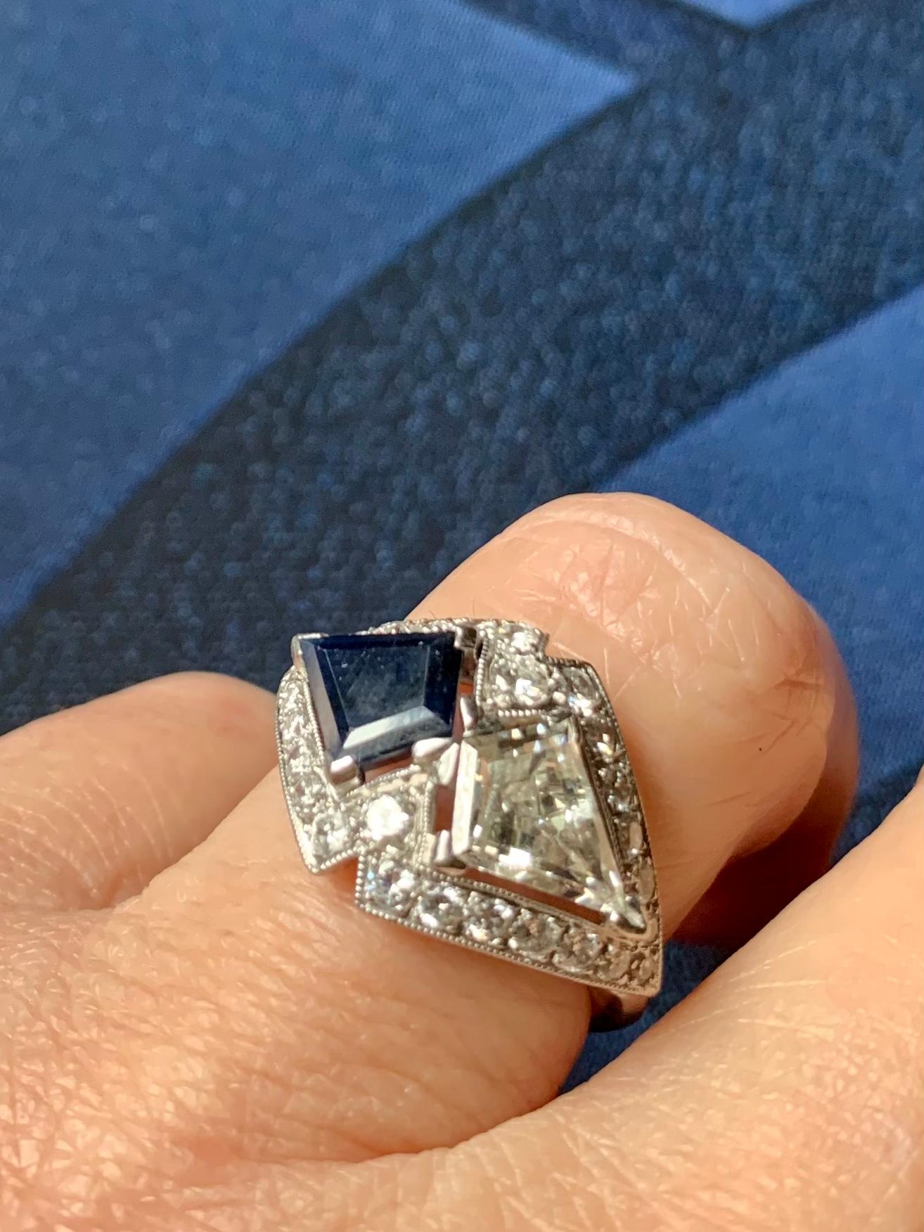 Stunning, rare Art Deco period platinum Moi et Toi ring featuring an impressive pair of kite cut natural diamond and natural sapphire gemstones framed by Old European cut and single cut diamonds. 
Sleek and Modern, distinctively Art Deco, this